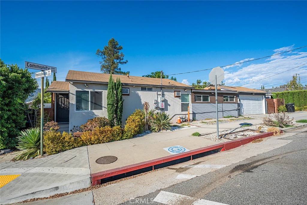 Why buy a condo and pay high dues! This single family home features a charming location tucked just below the Foothills, with easy access to the 210 Freeway! laminate entry flows seamlessly through the kitchen, which features granite counters and a cozy dining area, as well as into the hallway and bedrooms. A spacious family room addition with tiled floors and a welcoming fireplace offers a great space to relax or entertain and connects conveniently to the two-car garage with direct access. An adjacent laundry room includes the added bonus of a shower and toilet. Outside, you’ll find a covered patio with a wood deck, plus an additional tiled patio and another deck for multiple outdoor living options. Several storage sheds remain with the property, along with free-standing garage cabinets, refrigerator, and stacked washer and dryer. The home also offers central air/forced heating and a modern tankless water heater and two electric car chargers!