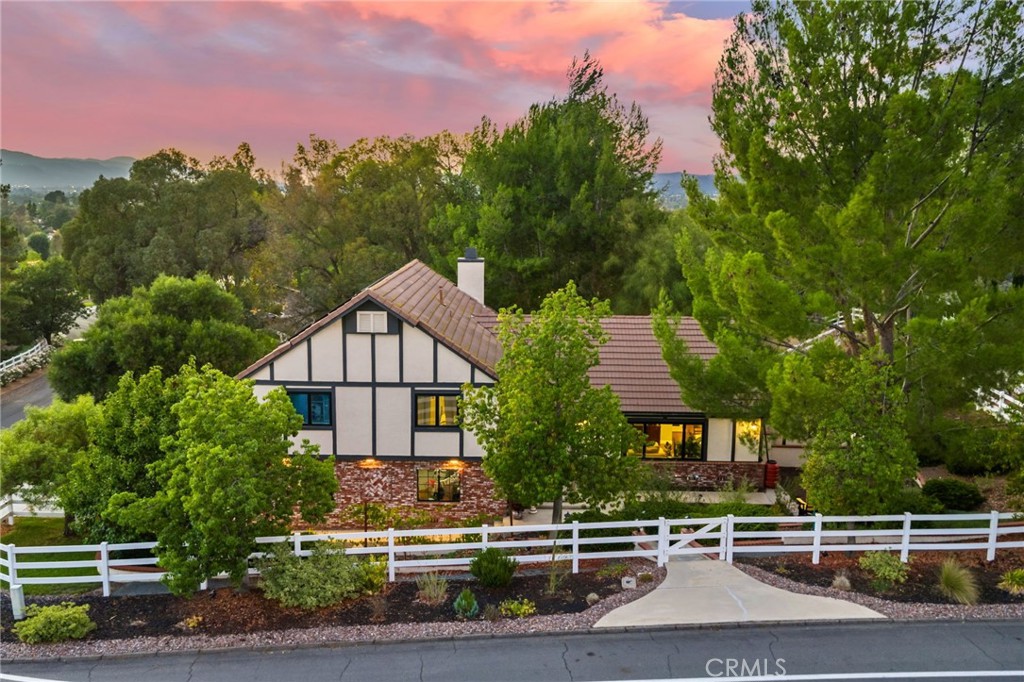 Welcome to Meadowview, one of Temecula’s most desirable neighborhoods! Ideally located in the heart of town—just minutes from top schools, the Promenade Mall, wineries, and restaurants—this home offers convenience while feeling like a world away. This beautifully updated home features 4 bedrooms, 3.5 baths, and 2,875 sq. ft. on a .53-acre usable corner lot. Upgrades include PAID solar, smart home features, a remodeled primary suite, a new upstairs HVAC system, and an incredible new outdoor living space. The upstairs waterproof deck—with sleek cable railing—expands your living area below, sitting above the covered patio equipped with fans, lights, an outdoor TV and soundbar and electric screens, making it perfect for year-round enjoyment. Inside, the gourmet kitchen opens to the living, dining, and family rooms and boasts a large granite island, abundant counter and cabinet space, pot filler, and stainless steel appliances including a 5-burner gas cooktop with hood, double ovens, microwave, dishwasher, and a new smart refrigerator. The large sunken family room is the heart of the home, complete with charming stone, wood burning fireplace and French doors that lead to the outdoor living area – perfect for relaxing or entertaining. Upstairs, the primary suite has been fully remodeled with a large tub, chandelier, separate shower and fitted walk-in closet. It is joined by two additional bedrooms, both with fitted closets and new glass doors. There is an additional full bath to complete the upstairs. Downstairs, a private bedroom suite with French doors to the backyard provides the perfect space for guests or multi-gen living. A convenient laundry room with an attached remodeled half bath and direct access to the backyard adds both function and flexibility. The expansive backyard offers endless potential—with room for a pool or ADU—and already includes a sport court for fun and recreation, plenty of mature trees which provide wonderful shade. Meadowview residents enjoy resort-style amenities including pickleball and tennis courts, two pools, clubhouse, sport courts, and scenic trails. This is truly one of the best locations in Temecula!