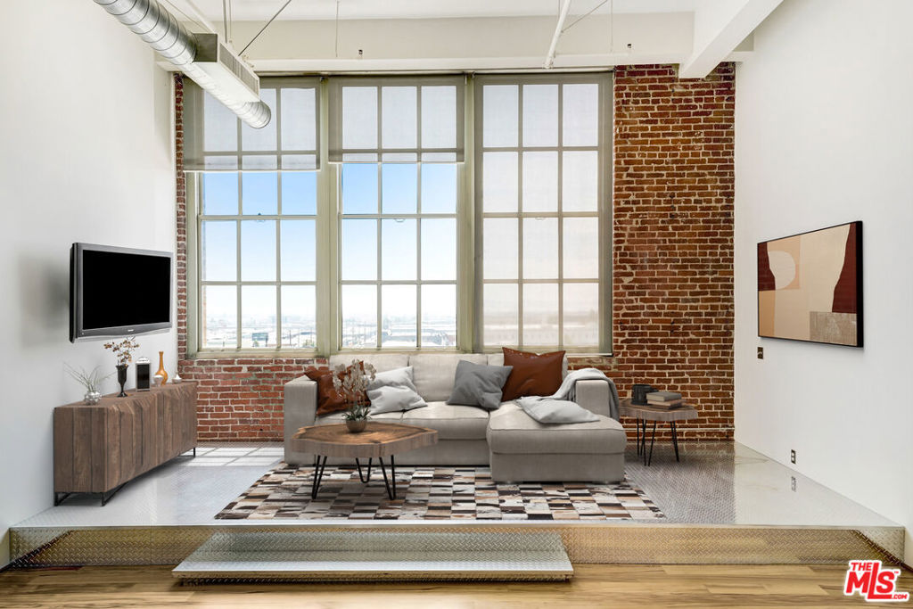 Live above it all in this exceptional top-floor unit at the historic Biscuit Company Lofts in the heart of DTLA's Arts District. Soaring ceilings, skyline views, and a thoughtfully added enclosed room and mezzanine loft offer the ideal balance of character and versatility, perfect for a creative studio, work-from-home setup, or guest space.This Mills Act-approved building means significant property tax savings, making ownership even more rewarding. Enjoy access to premium amenities including a resort-style pool, outdoor lounge with fire pit and BBQ, dog walk, and a state-of-the-art gym located just across the street at the Toy Factory Lofts. One dedicated parking space is included.Step outside and explore the best of the neighborhood. Walk to popular restaurants, cafes, breweries, and the exclusive SOHO Warehouse. This is a rare opportunity to own a piece of LA history with modern perks and unbeatable location.