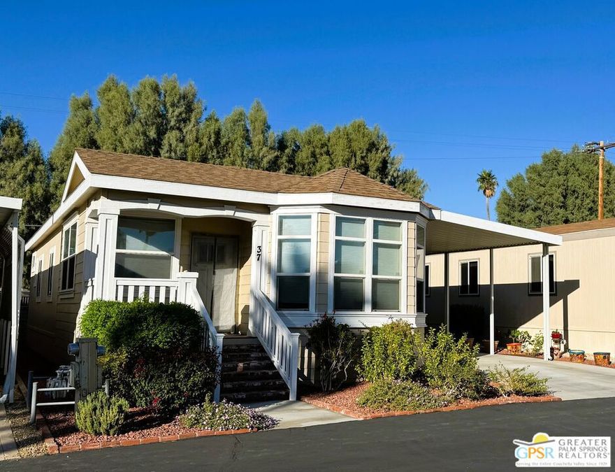 Welcome to the beautiful quaint 55+ community of Corkill Palms. This home is only 6 years old and it has been very well maintained and it comes COMPLETELY FURNISHED! All you need to move in are your clothes and toothbrush! It has only been used as a seasonal home so there is very little wear and tear. There are 2 large bedrooms and 2 baths. High ceilings in living room and dining/kitchen area with a spacious open concept. Beautiful solid wood cabinets in kitchen and baths with laminate counters and higher grade appliances.   The primary bedroom is large with lots of closet space with a closet organizer system. The second bedroom is extra large with office or craft space like the sellers are using it plus that has a closet organizer system as well.  There is a cozy porch on the front of the house plus space under the 2-car carport perfect for patio furniture and outdoor dining. There is also a great storage shed there as well. Some doorways are extra wide for wheelchair accessibility. The home also has a sprinkler and fire alarm system. Relax in the Therapeutic Hot Natural Mineral Springs at the Clubhouse or have some fun on the putting green or in the billiard room located very close by. This home is very clean and move in ready. Buyers must be approved by park before opening escrow.  Monthly space rent is approximately $540 but buyer will need to verity that with park manager as well as any utility charge amounts passed on to home owners. Contact us today to set up and appointment to see this wonderful home!