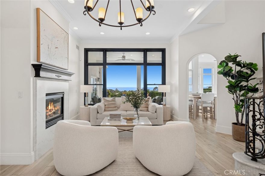 Stunning ocean views greet you the moment you enter this home in the exclusive, 24-hour guard-gated community of Sea Pointe Estates. This beautifully upgraded residence offers the ultimate in coastal luxury with unmatched panoramic vistas. Spanning approximately 4,072 square feet, this 4-bedroom, 3.5-bathroom home plus office features an open floor plan designed to maximize natural light and showcase the ocean. The dramatic entry with soaring ceilings and a sweeping staircase sets an elegant tone that continues throughout the home. Entertain impressively in a great room that captures ocean views and flows seamlessly into a genuine chef-caliber kitchen with custom cabinetry, an oversized island, Wolf, and Viking appliances, beamed ceilings, a Sub-Zero wine cooler, and additional Fisher & Paykel refrigerator/freezer drawers. The space opens to an ocean-view backyard designed for entertaining, complete with an infinity spa, tranquil waterfall feature, built-in Viking BBQ, gas fire pit, and multiple areas for relaxation. The main-level primary suite offers single-level living with wall-to-wall ocean views and a spa-inspired bathroom with a step-free shower and luxurious finishes. An office is also located on this level. Upstairs, three additional bedrooms and a spacious bonus room, ideal for a media or playroom, open to a sweeping view deck perfect for enjoying sunsets and whitewater coastline vistas. A private elevator provides effortless access between levels, and a secondary garage adds convenience. Residents of Sea Pointe Estates enjoy resort-style amenities including tennis courts, a clubhouse, pool, spa, and tot lot. Just minutes from magnificent beaches, upscale shopping and dining, the home offers easy access to historic San Juan Capistrano and Dana Point Harbor. Experience refined coastal living at its finest in this breathtaking San Clemente retreat.