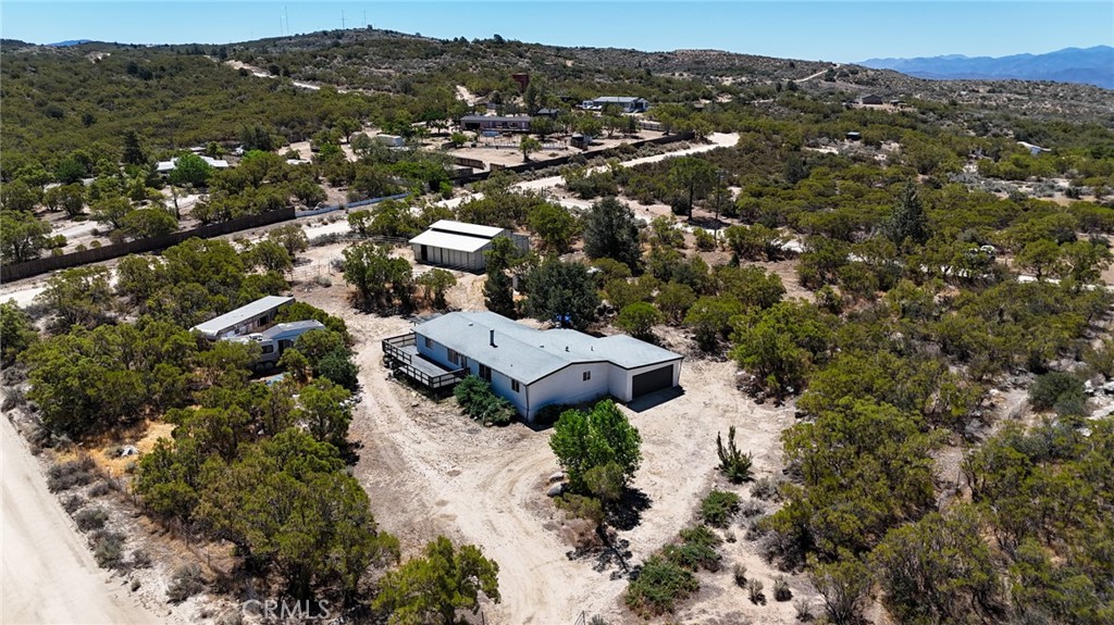 Welcome to your dream ranch retreat in the heart of Anza, California! This beautifully remodeled 3-bedroom, 2-bathroom home offers 1,680 square feet of comfortable living space, perfectly situated on a flat and usable 2-acre corner lot. This home features an open layout with a double-sided fireplace between the living and dining areas, updated flooring and finishes throughout, and a spacious primary suite with a soaking tub and separate shower. The upgraded kitchen and baths offer modern comfort. A two-car garage provides ample storage. Rv parking and a private water well offers self-sufficiency and peace of mind. This property is tailor-made for horse lovers and hobbyists alike. The well-equipped horse stable includes three generous stalls on one side, while the opposite side houses a large shop—perfect for tack, tools, or creative projects. A generous paddock allows plenty of room for your horses to roam and graze, with additional open land ideal for expansion, gardening, or simply enjoying the wide-open skies. The flat terrain and corner lot location provide easy access, privacy, and endless potential. Located in the peaceful high-desert community of Anza, enjoy mountain views, four-season climate, and outdoor recreation nearby. Just a short drive to Temecula or Palm Springs, Anza offers rural living with convenient access to amenities. Ideal for horse lovers, hobbyists, or anyone looking for space and serenity in Southern California.