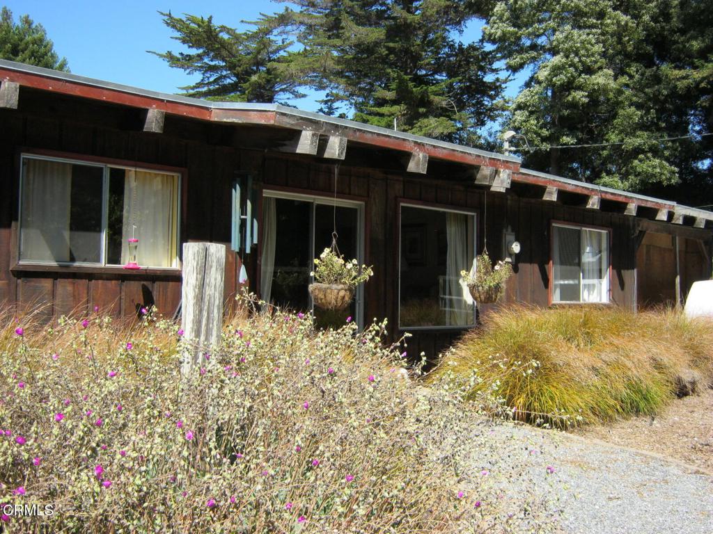 Near end of road privacy and 1.73 acres in the sunbelt.  Possible horse property. Put your green thumb to work in the front yard raised planter boxes or the fenced garden area in the backyard.  Numerous outbuildings and some redwood trees.  The rustic house features a huge support column and beam.