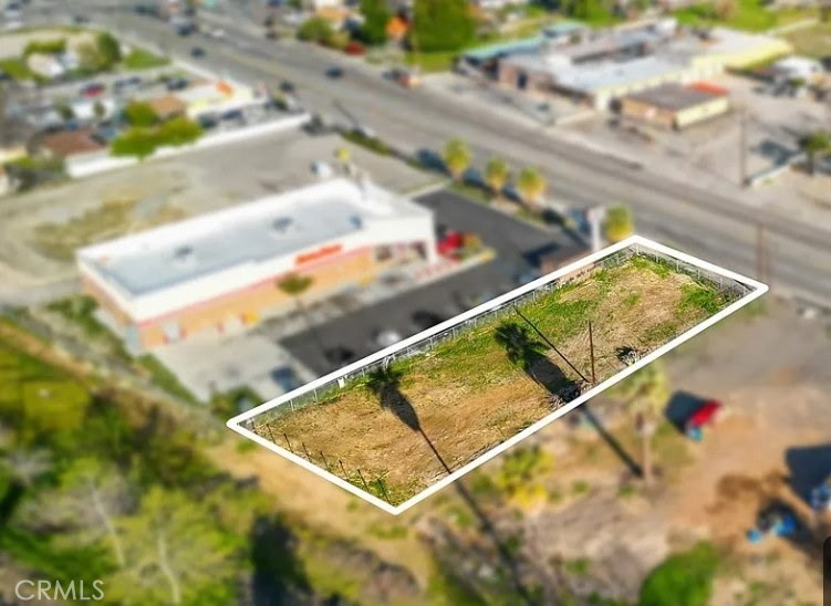 Prime commercial vacant lot located on the high-traffic corridor of W Highland Ave in San Bernardino, just west of the 210 Freeway. This 0.257-acre flat parcel (approx. 11,220 sq ft) is zoned CG (Commercial General), allowing for a wide range of development possibilities including retail, office, medical, drive-thru, mixed-use, or residential with ADU potential. Surrounded by established businesses such as AutoZone, 76 Gas, and other neighborhood services, this highly visible site offers excellent street frontage, strong traffic counts, premium signage exposure, and access to public utilities including water, gas, electricity, and telecom. Ideal for investors, developers, or owner-users looking to capitalize on a growing commercial area, this lot presents a rare chance to bring your vision to life in one of San Bernardino’s busiest corridors. With high demand for quality commercial space and proximity to freeways, schools, and residential neighborhoods, this site is a perfect match for a wide range of business types or a long-term ground lease investment. Utilities are at the street, and the land is level, minimizing upfront construction costs and expediting development timelines. Whether you're planning a nationally branded retail site, a modern professional building, or a mixed-use concept, this parcel offers unmatched potential for cash flow and value growth. Buyer to verify zoning, usage, and all applicable requirements with the City of San Bernardino. Don’t miss this opportunity to build something impactful in a high-demand area with built-in foot traffic and long-term value.