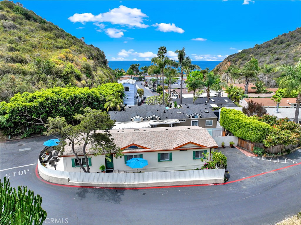 What's better than beach life in Laguna? And the tropical enclave of Laguna Terrace is no exception! Here is a community of custom manufactured homes that will surprise & delight the discerning Buyer. Who knew there could be SUCH affordable housing in iconic Laguna? Conveniently located where Laguna life is at your doorstep, come see one of the best kept secrets along the California coast. This gorgeous 3 bedroom, 3 bath cottage has all the charm & character of a custom beach home along with an affordable price tag. And just LOOK where you're located! Across Coast Hwy. from the world-famous Montage Resort, Spa & world class beaches, down the street from The Ranch Resort, Spa & golf PLUS within walking distance to some of the best dining options in Laguna! This home has been lovingly cared for by the same family for over 30 years and now is ready for another lucky owner. Come experience all you enjoy in an environment of comfort, style & convenience. Enter through carefully kept landscape, bowery and flower garden with a productive lemon tree giving you that cozy feeling of home. The large, wood wrap around deck surrounds the exterior & offers outdoor living, dining, relaxing & sunset views. High ceilings & open floor plan greet you as you enter the front door. Abundant natural light graces the entire property through multiple skylights & ceiling fans keep the cool coastal air in motion. Upgraded kitchen and bathrooms exude luxury along with that simple, Boho chic feel. And did we mention the ample dedicated & guest parking, large storage shed & plenty of extra room on the side yard? You GOTTA see this place! Manufactured home living is quite different at Laguna Terrace. You’ll need to see it to believe it. This property has all the features of a million dollar home at half the price. Community amenities are abundant with pool, spa, clubhouse & gym located in a luxurious tropical setting. Summer's the perfect time to consider this lifestyle of ease and simplicity. We looking forward to seeing you and saying “Welcome Home!”