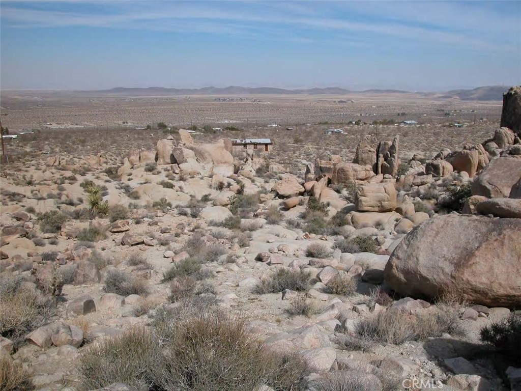 Parcel 0604-081-09, 5.08Acres; Parcel not to be accessed without owner’s presence & neighbors are not to be disturbed. World class parcel unique for custom organic architecture such as Couelle, or Lautner. Kellogg Hi-Desert House, located about 3 mi due East in similar terrain. Desert solitude, privacy, vistas, rock climbing with nearby suburban amenities. Shielded by 2 SFR parcels and 2 BLM parcels. Elec Pwr, & Water Utilities within 1-2 parcels of site. On site mountainous boulders (up to 30ft dia.) allows flexibility in custom structural design, & stone art sculpting. The parcel has about a 300ft vertical rise in elevation. Within 3/4 mile of Medical Emergency Room and Law Enforcement facilities. Same latitude as the Joshua Tree Natl Park, N Boundary, between Joshua Tree and 29 Palms entrances.