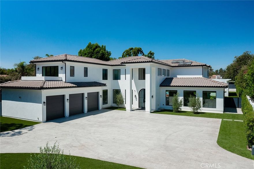 Welcome to this stunning newly constructed estate in the exclusive Weddington Estates enclave of Sherman Oaks. Set behind private gates on a sprawling corner lot, this home blends luxury, comfort, and smart living with effortless style. Featuring 5 spacious bedrooms and 4.5 luxurious bathrooms, the residence showcases white oak flooring, sophisticated smart home technology, and exceptional indoor-outdoor flow—perfect for entertaining. Step through custom arched iron double doors into a light-filled, open-concept layout designed for grand living. The formal living and dining areas unite into a dramatic great room with expansive windows that flood the space with natural light—ideal for both hosting and relaxing. The gourmet chef’s kitchen is equipped with top-of-the-line appliances, a built-in Thermador refrigerator and freezer, full-size wine fridge, and a butler’s pantry. It opens to the inviting family room, complete with a sleek fireplace and oversized Fleetwood pocket sliding doors that lead to your private, resort-style backyard. The main level also includes a media room, custom wet bar with wine fridge, and a versatile guest suite with en-suite bath—perfect for visitors or in-laws. Upstairs, you'll find three generously sized bedrooms, including two en-suites with custom walk-in closets. The primary suite is a luxurious retreat with pocket doors that open to a private balcony, his and hers walk-in closets with built-ins, and a spa-inspired bathroom with dual vanities, an oversized soaking tub, and a double rainfall shower. A conveniently located upstairs laundry room adds functionality. Outdoors, the resort-style backyard is designed for unforgettable gatherings. Enjoy a sparkling pool and spa, two enclosed recreation cabanas, a putting green, and two covered patios—including an oversized space with a fully equipped outdoor kitchen and BBQ area for the ultimate open-air lounge experience. This backyard is a true entertainer’s dream. Smart home automation powered by Control4 provides seamless control of lighting, integrated sound system including sonos, climate, pool, spa, and more—delivering unparalleled comfort, convenience, and modern luxury throughout. This estate also caters to the car enthusiast, featuring a spacious 3-car garage, three separate gated entrances, and an expansive driveway that offers ample parking for multiple vehicles.