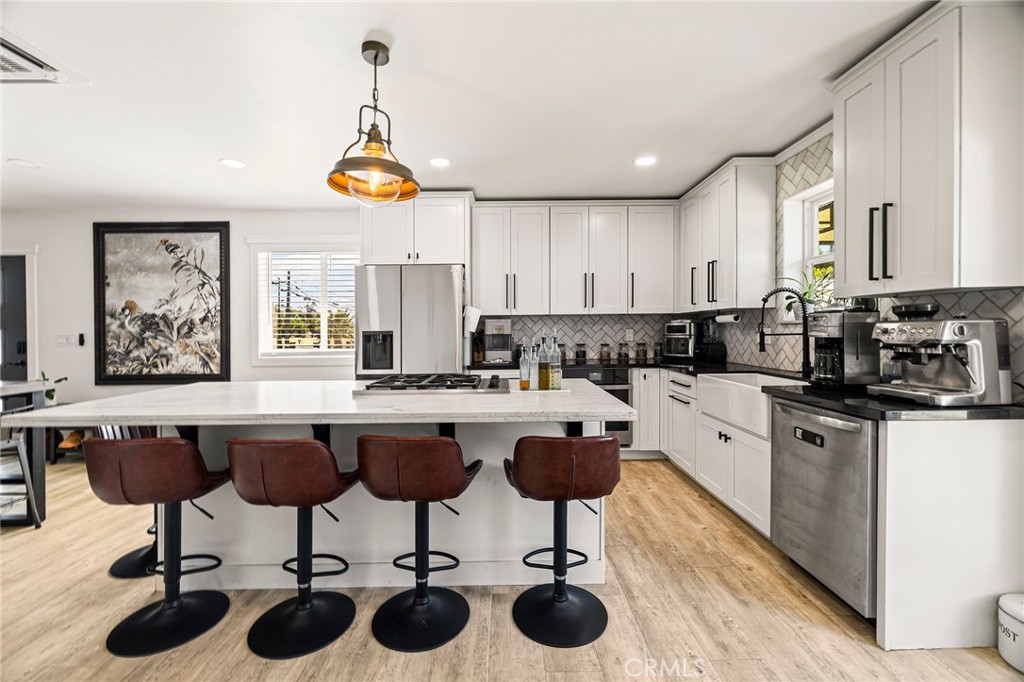 This beautifully updated modern farmhouse seamlessly blends charm with contemporary comfort. Set on more than half an acre, the home features a brand-new exterior with fresh siding and a durable standing-seam metal roof. Step inside to discover custom finishes throughout, including solid knotty interior doors and a thoughtfully designed layout.
The heart of the home is a stunning custom kitchen, equipped with quartzite and marble countertops, abundant cabinetry for all your storage needs, and a layout perfect for entertaining. Both bathrooms have been upgraded with frameless custom showers, creating spa-like retreats.
Enjoy year-round comfort thanks to a new, energy-efficient mini-split system. Additional highlights include an indoor laundry room with extra storage, a spacious back deck ideal for gatherings, and serene outdoor space ready for your garden, play area, or future expansion.
This turnkey property is the perfect mix of modern luxury and farmhouse charm—don't miss your chance to make it yours.