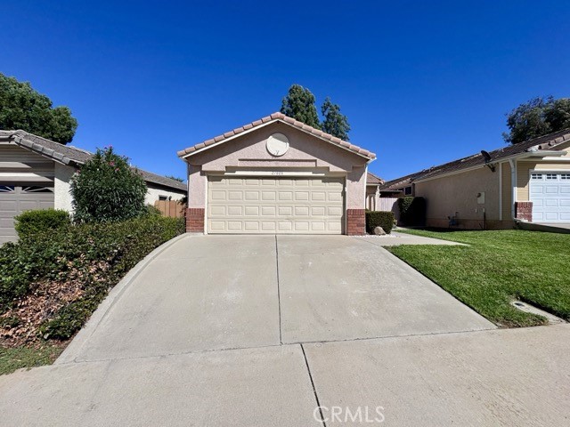 This charming single-story home offers a fantastic layout, a spacious fenced yard, and an attached two car garage. Inside, you'll find upgraded flooring throughout, no carpet, with over 1,100 sqft., 3 bedrooms, and 2 bathrooms. The living room is bright and inviting with a cozy fireplace and plenty of natural light. It flows seamlessly into the dining area and kitchen, creating an open and functional space perfect for everyday living or entertaining. The kitchen features brand new stainless steel appliances, durable tile countertops, and freshly painted cabinets. A convenient indoor laundry area is located just off the kitchen. Down the hallway, you'll find all three bedrooms and both bathrooms. The primary bedroom is spacious and includes an attached ensuite with dual sinks and a shower/tub combo. Both bathrooms have been updated with brand new toilets for added comfort and convenience. Venture outside to a low-maintenance backyard complete with rock landscaping, garden planter boxes, and a storage shed, ready for you to enjoy and make your own. Landscaping is included in the price for this beautiful home! Located in a welcoming community that offers fantastic amenities, including a pool and jacuzzi, park, basketball court, BBQ/picnic area, and a large grassy space, all just a short distance away. Don’t miss out, schedule your showing today!
