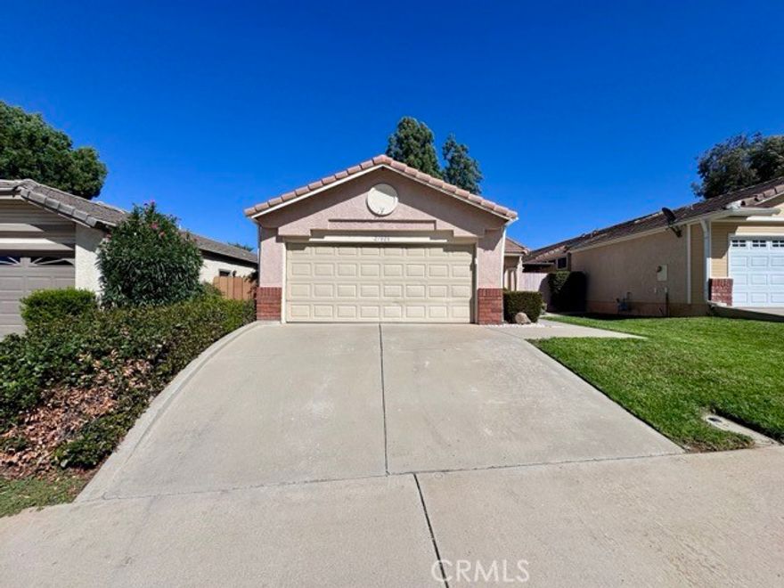This charming single-story home offers a fantastic layout, a spacious fenced yard, and an attached two car garage. Inside, you'll find upgraded flooring throughout, no carpet, with over 1,100 sqft., 3 bedrooms, and 2 bathrooms. The living room is bright and inviting with a cozy fireplace and plenty of natural light. It flows seamlessly into the dining area and kitchen, creating an open and functional space perfect for everyday living or entertaining. The kitchen features brand new stainless steel appliances, durable tile countertops, and freshly painted cabinets. A convenient indoor laundry area is located just off the kitchen. Down the hallway, you'll find all three bedrooms and both bathrooms. The primary bedroom is spacious and includes an attached ensuite with dual sinks and a shower/tub combo. Both bathrooms have been updated with brand new toilets for added comfort and convenience. Venture outside to a low-maintenance backyard complete with rock landscaping, garden planter boxes, and a storage shed, ready for you to enjoy and make your own. Landscaping is included in the price for this beautiful home! Located in a welcoming community that offers fantastic amenities, including a pool and jacuzzi, park, basketball court, BBQ/picnic area, and a large grassy space, all just a short distance away. Don’t miss out, schedule your showing today!