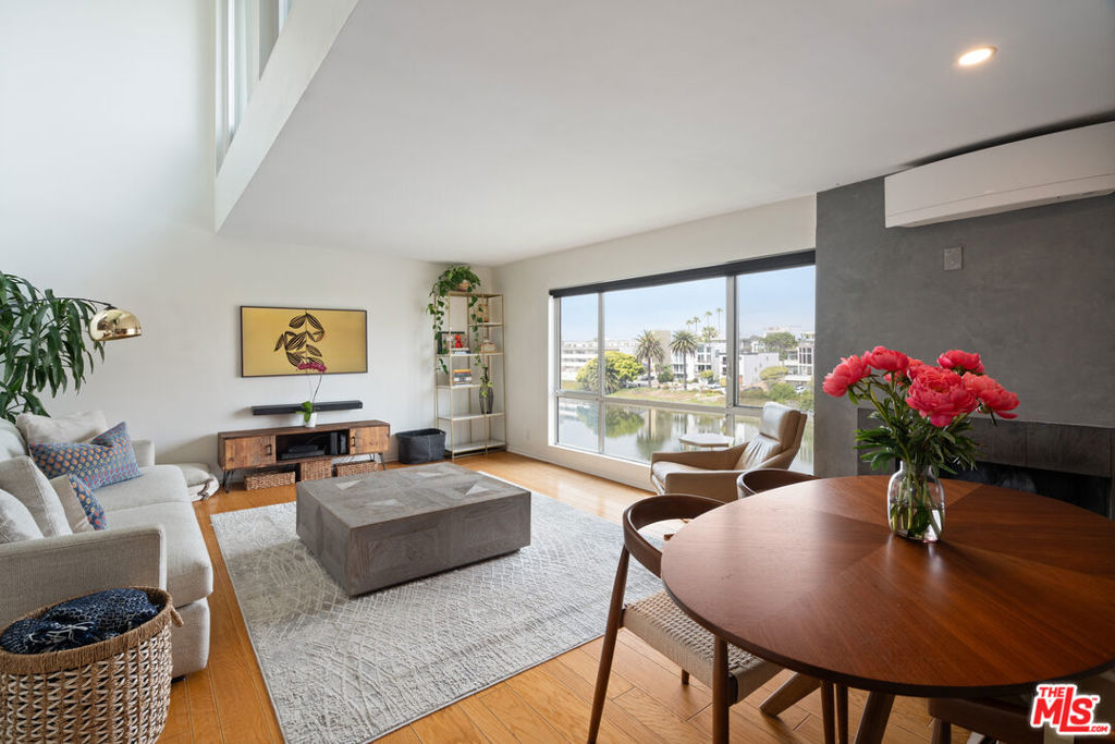 Your serene coastal residence awaits! One block from a peaceful stretch of beach, this light-filled top-floor home showcases refined interiors and water views from most windows -- effortless comfort at the coast. In addition to two full-sized bedrooms, a large den provides flexible space for an office, reading room, or common space, and further enhances its livability. A private deck offers the perfect space for outdoor entertaining with sweeping views of the neighboring lagoon or stargazing at night next to a fire pit. This thoughtfully appointed home blends polished design with everyday functionality. Nearby, you'll find parks, beloved local dining, and cafes all within a three-minute walk. With its quiet setting, natural light, and curated details, you've found a rare opportunity to experience elevated beachside living. Other highlights include in-unit laundry, AC, two parking spots, as well as additional private storage in the garage and a shared bike room.