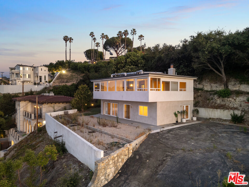 Rare opportunity to own three parcels with 3 APNs, totaling over 24,000 square feet tucked away in the hills of Sherman Oaks, South of Ventura Blvd. This beautiful contemporary residence offers panoramic views and unmatched privacy. Three lots for the price of one in one of LA's most sought-after hillside neighborhoods.Spanning over 2,500 square feet, the home features 4 bedrooms and 3 bathrooms, designed with a seamless blend of modern finishes and warm natural light. Large windows showcase the sweeping views from most rooms, while multiple outdoor areas offer ideal spaces for entertaining or peaceful solitude above the city. The property's expansive grounds invite endless possibilities, from future development to lush landscaping or private outdoor amenities. The open concept main level includes spacious living and dining areas that flow into a sleek kitchen, all positioned to capture the incredible views. The primary suite includes direct outdoor access while additional bedrooms offer flexibility for guests, home offices, or creative studios. Located just minutes from the vibrant lifestyle of Ventura Blvd, you're moments away from fine dining, boutique shopping, fitness studios, cafes, and some of the best entertainment the Valley has to offer. This is more than a home, it's a private hillside sanctuary with the space, views, and location to match.