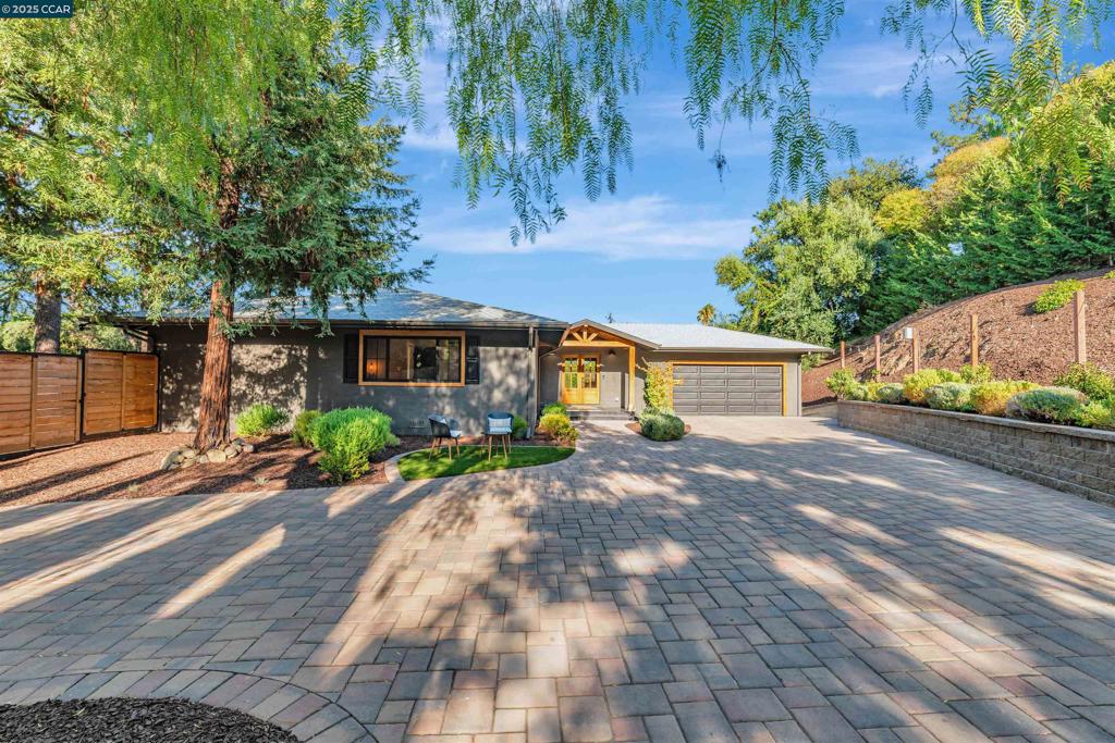 This beautifully reimagined smart home was completely rebuilt from the studs and showcases thoughtful design with high end finishes throughout, featuring 4 bedrooms, 2 bathrooms and almost 1,800 square feet of expansive living space. The open layout flows from the spacious living room with a sleek linear gas fireplace into an inviting dining area and a chef’s kitchen highlighted by quartz counters, a 36 inch gas range, and built in smart refrigerator. Commercial grade heating and cooling ensure year round comfort, complemented by bamboo hardwood floors, solid mahogany doors, and Andersen dual pane windows with French sliding glass doors. The guest bath offers a custom concrete vessel sink with wall mounted faucets, while the primary suite boasts a designer built-in closet and spa inspired bath with dual vanities, cement sinks, floor to ceiling tile, a curbless entry shower, and dual shower heads. Outdoor living shines with sweeping views of Mt. Diablo, professionally designed low maintenance landscaping, two Trex decks, a full outdoor kitchen with white granite counters, and a hand welded automatic driveway gate that enhances privacy. Striking exterior lighting completes the home’s curb appeal. Ideally situated in St. Francis Park close to shopping, dining, and neighborhood parks