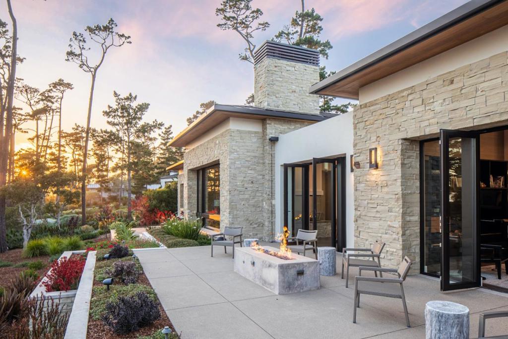 Located within walking distance to the Lodge at Pebble Beach is where you'll find this single-level, modern home on nearly an acre lot with beautiful ocean views. The interior, replete with voluminous rooms and high ceilings throughout, offers 4 suites including a luxurious and private master suite with dual closets, soaking tub, and patio. Highlights include a statement glass fireplace, designer lighting, Bassano white oak floors with radiant heat, indoor/outdoor sound system, lush landscaping with rare plants, motorized shades, and a large back patio with fire pit to enjoy the sunsets. With an ideal balance of indoor/outdoor access, you can entertain friends and family and live with the calming sounds and pleasant sights of the ocean. Newly constructed in 2017, this is truly a special offering ready for its next fortunate owner.