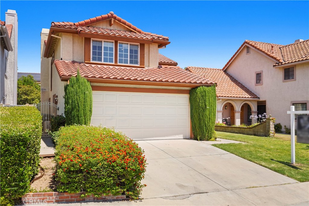 Say hello to California Living at its best! Enjoy the security of this updated home in the 24-hour GUARD GATED community of Porter Ranch Estates! The updated home offers 3 recently upgraded spacious bedrooms and 2.5 bathrooms, a renovated eat-in kitchen and newer appliances, and sliders that lead out to the pool-sized private back yard. The home is further enhanced by large plank hardwood floors, recessed lighting, and a newer AC. The family room is warmed by the stone fireplace. The large dining room has sliders leading out to the well-landscaped back yard with fruit trees. Enjoy the convenience of a built-in bar and wine cooler, the comfort of the spacious primary bedroom containing two closets, and the high-quality built-in cabinets throughout. You'll love the family-oriented gated community boasting its community pools, tennis courts, basketball court, and more. Its proximity to major shopping hubs and the security of a 24-hour gated community make this beautiful place your FOREVER home.
