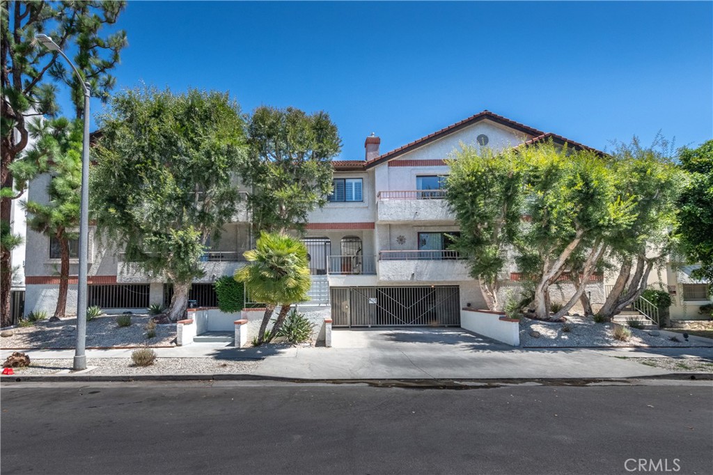 Welcome to this rare, front-facing three-bedroom residence in one of Studio City’s most desirable neighborhoods, Colfax Meadows. Nestled on a picturesque tree-lined street, this top-floor condo offers ultimate privacy with only one shared wall and no one above—plus the exclusivity of a boutique building with just 14 units. Step inside to an expansive light-filled living room with a cozy gas fireplace and a west-facing balcony that soaks up sunshine all afternoon. The open-concept chef’s kitchen features a large center island, premium JennAir stainless steel appliances, a farmhouse sink, subway tile backsplash, and abundant cabinetry—all accented with modern finishes and hardware. Throughout the condo, you’ll find thoughtful design touches such as wainscoting, upgraded fixtures, and contemporary style. The luxurious primary suite is a true retreat, with an oversized layout, a sleek en-suite bath boasting a frameless glass shower, a designer vanity, and generous closet space. Two additional bedrooms—both spacious and filled with natural light—share a modern hallway bathroom with a shower-over-tub. Additional highlights include: Smart-home features, in-unit washer & dryer, two side-by-side parking spaces + guest parking, jacuzzi pool/spa, pet-friendly building, and HOA dues include earthquake insurance. All this in the highly sought-after Amazing School District, just moments from Studio City’s hottest restaurants and markets—Erewhon, Firefly, Vitello’s, Aroma Cafe, and Salt & Straw are right outside your door. This is modern Studio City living at its finest—a rare opportunity you won’t want to miss!