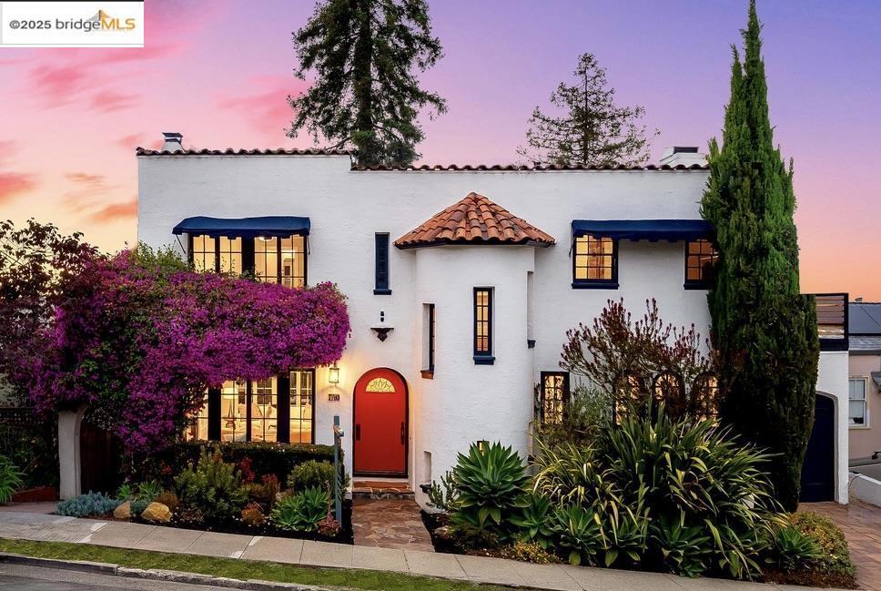 Exceptional Mediterranean Architecture w/ Oakland views in the heart of Crocker Highlands. Stunning kitchen w/ marble counters, designer backsplash, Shaws sink, copper pot faucet, built-in Miele espresso machine, wine fridge, Viking fridge, microwave & 6-burner range w/ grill & dbl oven, ctr island, built-in seating & travertine floors. Main lvl powder rm w/ stately accents & custom tile. Sunny dining rm flows to light-filled living rm w/ orig fireplace & French windows opening to spacious deck w/ neighborhood views. Upstairs: 3 BRs (all w/ auto shades), primary suite w/ Juliet balcony, sleek remodeled bath w/ dbl vanity & frameless glass shower; 2nd BR w/ great light & exterior balcony; 3rd BR w/ balcony over rear gardens. Striking hall bath w/ custom tile & vessel sink. Park-like gardens w/ turf play area + play structure. Also AC & garage ideal as flex space w/ EV charger. Minutes to award-winning elem, Lakeshore shops/restaurants, & quick access to Bay Bridge/SF. Views: Downtown