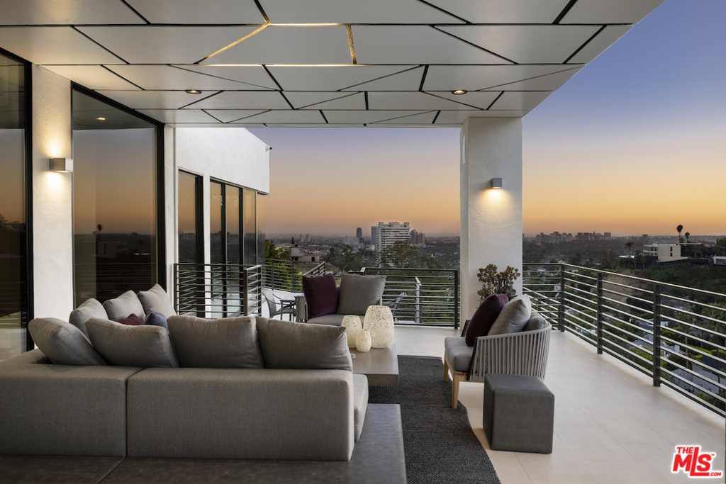 Privately perched behind a gate on the quiet side of The Bird Streets and moments from Sunset Plaza, this 6,500 sqft modern residence delivers emotional city and ocean views from nearly every vantage point. Originally built in 2004, the current stewards executed an extensive renovation and reprogram, to maximize light, views, and functionality. Walls of glass blur the line between inside and out, integrating a private pool, spa, and 3,000 sqft of deck space. The main level is wide open, capable of hosting a substantial gathering. The great room with fireplace and bar runs the width of the house. A formal dining room connects to a gourmet kitchen. The elevator leads to the primary suite, equipped with bar-lounge, fireplace, spa-like master bathroom, a giant walk-in closet, and serene Zen garden. Other amenities include: a three-car garage, generously-sized guest suites, media room, a fully equipped gym, wine storage, audio throughout, and the scale worthy of a collection of art.