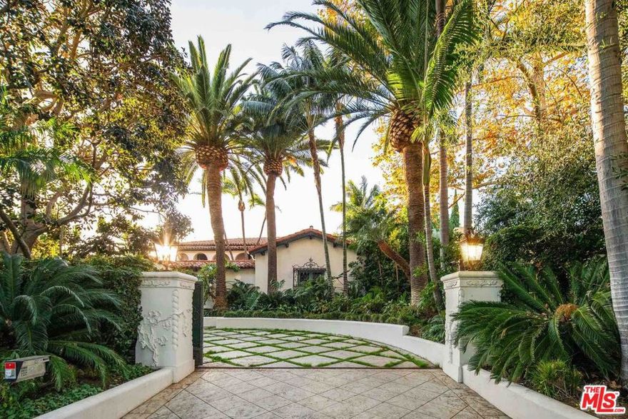 Located on arguably the best block in Beverly Hills, behind the gates you'll discover the charm and authenticity of this meticulously renovated 1920's Spanish Villa, steeped in Hollywood history. One of the most sophisticated and authentic estates on the market today, the home boasts 6 beds, 7.5 baths in over 10,000 square feet of luxe living space across three separate free-standing structures on an expansive 28,000sf private lot. Reimagined by AD100 Steven Johanknecht and Commune Design, and published in Elle Decor, the period details were extremely well respected. Upon entering the gates, guests are welcomed into a charming courtyard with a rare Batchelder-designed fountain, a carved plaster facade with clay roof tiles, with wrought ironwork throughout, while inside you'll find hand-stenciled wood beamed ceilings, large wide arched doorways and wood and inlaid floors. The chef's kitchen with eat in breakfast area, dining room and family/media room with built in bar and a wall of glass, executive office with fireplace and a 1000-bottle temperature controlled wine room, all lead to romantic courtyards and gardens.  The primary suite offers walk-in dressing rooms, luxurious bath, and private office. Enjoy a resort style pool and spa, an 800-SF gym and a back courtyard with a covered sitting area, outdoor barbecue, full catering kitchen and a bar. The guest house offers a kitchen, two beds, a full bath and a sitting area on the second floor, while the first floor includes another sitting area and a full bath.  With three separate completely private dwellings adorned by award-winning landscape architecture, this true Spanish Colonial compound is a trophy property for the most discriminating and sophisticated collector.