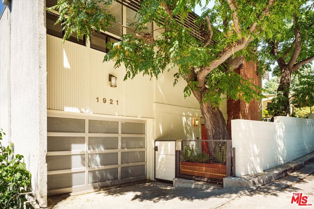Architectural Post-and-Beam with Iconic Views. Perched in the heart of Silver Lake, this rare mid century residence was designed and built in 1959 by renowned architect Leonard Brunswick as his personal home. A striking example of Post-and-Beam modernism, the property showcases Brunswick's timeless design principles, clean lines, open spaces, and a seamless connection to the landscape, view and endless blue skies. Set on a private street to street hillside lot, the home offers breathtaking panoramic views of the Hollywood Sign, Griffith Observatory, and beyond. Expansive walls of glass flood the interiors with natural light, while framing iconic Los Angeles vistas from nearly every room.The main living area features soaring ceilings, original beam detailing, and wraparound glass that dissolves the boundary between indoors and out. Thoughtfully preserved and minimally altered, the home retains its mid-century character. The 3-bedroom, 2 1/2 bath layout includes a primary bedroom suite with newly remodeled bathroom and decorative fireplace, an expansive second bedroom with jaw dropping views, a smaller bedroom, suitable as a nursery or intimate guest room and a sun-drenched studio/office ideal for creative work. Outside, off the the kitchen and living space, an expansive deck with plenty of room for dining or lounging and, in the private and gated front yard, a cozy redwood hot tub for evenings stargazing or an early morning soak. Located moments from Sunset Junction and a stones throw to all of the exciting shops and restaurants in Silverlake, Los Feliz, Atwater and Echo Park - this is a chic and easy getaway, the perfect spot to rest and reflect, to gather and to celebrate. A warm and wonderful home with beautiful bones, style, pedigree and forever views - where you can watch the sun rise and set, create a peaceful life and enjoy all that the area has to offer.