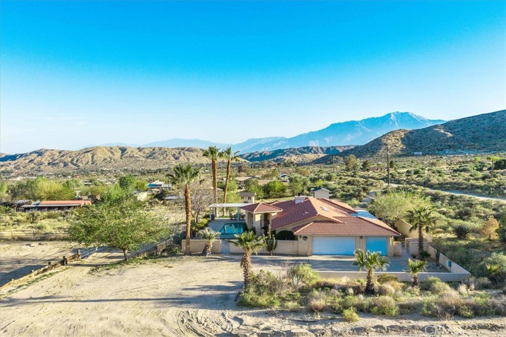 Welcome to your dream home nestled in the scenic hills of Morongo Valley. This stunning 4-bedroom, 3-bathroom home spans 1,832 square feet and sits on 2.32 acres of fully usable land, designed for both luxury living and equestrian lifestyle.
As you arrive, a stately saguaro cactus greets you at the custom metal gate entrance, setting the tone for the property's desert elegance. Built in 1990, the home features timeless Spanish-style architecture, including a classic clay tile roof and hand-laid custom Spanish tile throughout—from the floors to the bathroom backsplashes. Unique artisan sinks and warm design elements add charm and character to every corner.
Step inside to find a spacious, light-filled living room with a fully functional fireplace, perfect for cozy desert nights. The open-concept kitchen offers plenty of counter space and flows seamlessly into multiple dining areas, ideal for entertaining. Central AC, Heat and ceiling fans throughout the home ensure year-round comfort.
Outdoors, enjoy resort-style living with a sparkling pool and hot tub, a private back patio with mature landscaping, and a brick privacy wall—your very own sanctuary under the desert sky.
Equestrian enthusiasts will be thrilled by the three well-maintained horse corrals, a dedicated hay barn, and a private Tack Room complete with electricity. Property has a Round Pin, Two Mare Motels w- a run and a small Arena. A rare three-car garage offers ample space for vehicles, tack, or toys. RV Hookup with water, a 30 amp/ 50 amp and a 110 Volt panel box professionally done.
Whether you're looking for a permanent residence, vacation getaway, or income-producing retreat, this property combines the serenity of Morongo Valley with the luxury of refined desert living. If you've been searching for a home with acreage, views, horse facilities, and a pool—this is the one.