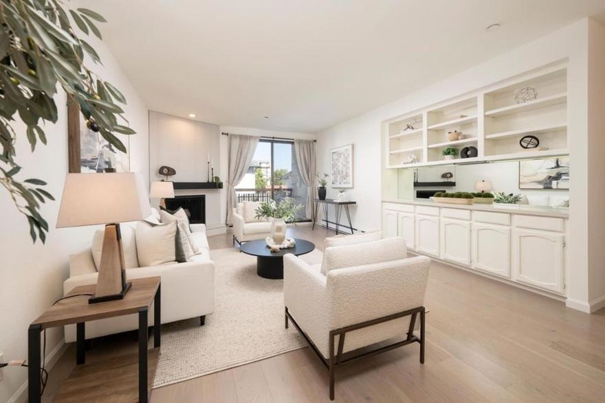 Say Hello to your new address! 2 Bed/2 Bath one-level unit (no stairs) in the heart of downtown! Embrace a walkable lifestyle with Central Park across the street and vibrant Downtown as your backyard, filled with shops/dining/fitness, and entertainment. DETAILS TO LOVE:  Bright, modern kitchen shines with stainless steel appliances, crisp white cabinetry, quartz counters, and stylish tile backsplash. Generous storage and layout make it as functional as it is beautiful + curved archway adds charm and warmth, leading into the dining area. The living room feels instantly comforting with its charming archway, built-in shelving for books and little treasures with mirrored back that reflects natural light, and a cozy fireplace that anchors the space. Sliding doors extend the living outdoors to a covered balcony, perfect for unwinding year-round. Primary suite. In-unit laundry for convenience. BUILDING: Furnished rooftop deck w/BBQ and sweeping views, secure 2-car parking, storage, Seamless access w/ButterflyMX, trash chutes/elevator. Dues cover water/garbage. All commutes are simplified with Caltrain just blocks away, quick freeway access,10 min to SFO, proximity to leading employers. BONUS: Unit can be rented, giving you flexibility whether you are buying as a home or an investment.