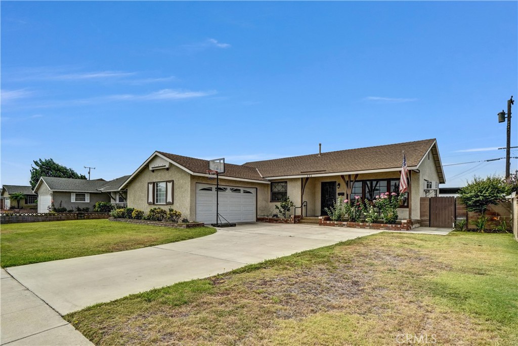 Charming single-story home within walking distance of Cal State University Fullerton! Offering 3 bedrooms and 2 bathrooms, including a spacious master suite with a beautifully renovated bathroom, this home combines comfort and convenience. A welcoming front porch leads into a large living room and kitchen with ample cabinet space. Enjoy nearly 400 sq. ft. of additional living area in the enclosed sun-room, perfect for relaxing or entertaining. The low-maintenance backyard features a covered patio, while the finished 2-car garage provides built-in cabinets, a workbench, and an oversized laundry sink. Close to schools, shops and restaurants. Thank you for showing.