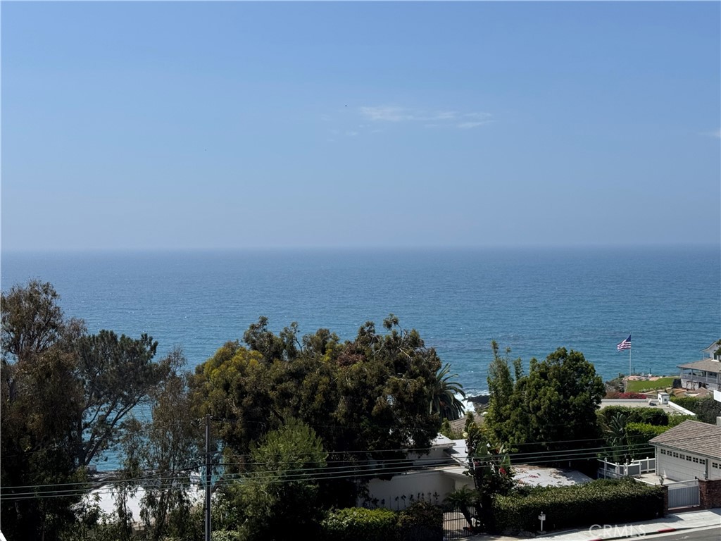 Ocean views and with three bedrooms and two bathrooms in beautiful Laguna Beach. This remodeled apartment is the only three bedroom in the complex and has beautiful luxury vinyl wood flooring, modern bathrooms a kitchen that is nicely appointed with new appliances, white cabinetry, quartz countertops, and an island for those morning breakfasts and coffee. Also has an in unit stackable washer/dryer. Add in a nice dining/main living area just off the kitchen that spills out to the ocean view patio. When it's time to explore the amazing things that Laguna Beach has to offer just jump on the Laguna Beach Trolley and leave your car in the garage. Woods Cove and Moss Street Beach are just a short walk from your apartment when it's time to hit the beach. This complex offers a shared common area to take advantage of quite time, barbecues, of quality time with family and friends. Put this apartment on the must see list of place to tour.