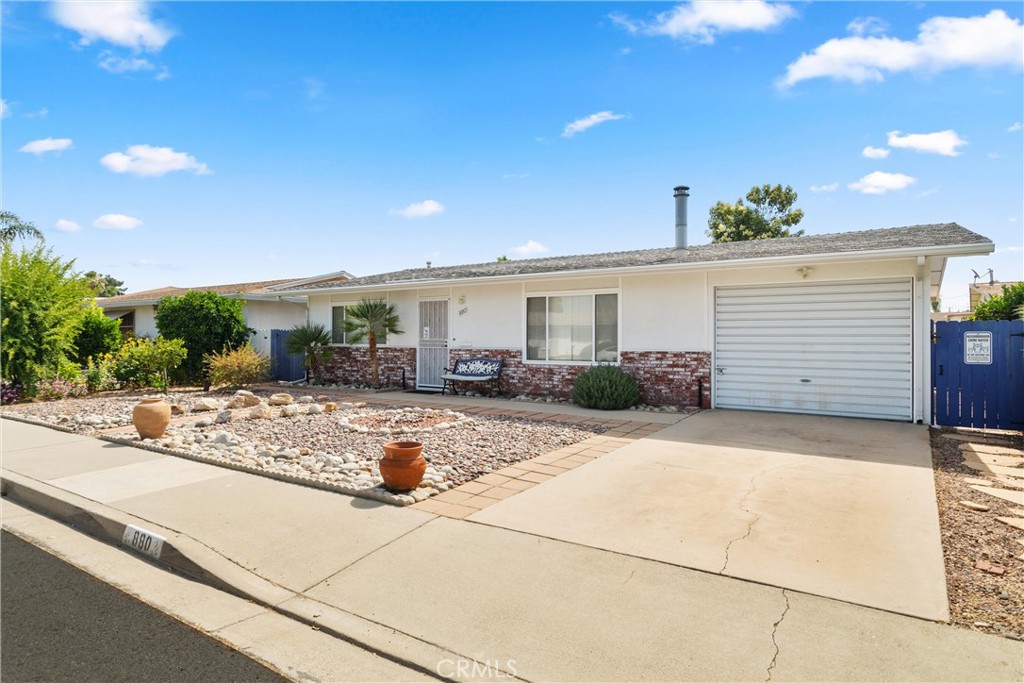 Welcome Home! This charming two bedroom, one bathroom home offers a spacious bonus room/ flex space off the dining room that opens to the backyard. Enjoy your private laundry room, complete with a utility sink, ideally located off the the bonus room and garage. The kitchen has tile floors and a good amount of cabinets. Both bedrooms are spacious and have large closets. The two hallway closets also provide an abundance of storage space. Enjoy the community pool and amenities on the warm summer days and cozy up next to the quaint wood burning stove in the winter. The backyard has an access gate to the community pool and horse shoe pits, etc. Ample natural light throughout the home. Additional features include central air conditioning, ceiling fans, tiled and laminate flooring throughout and a newer water heater. Located in the 55+ Sun Park II community and in convenient proximity to parks, restaurants, shopping and more!