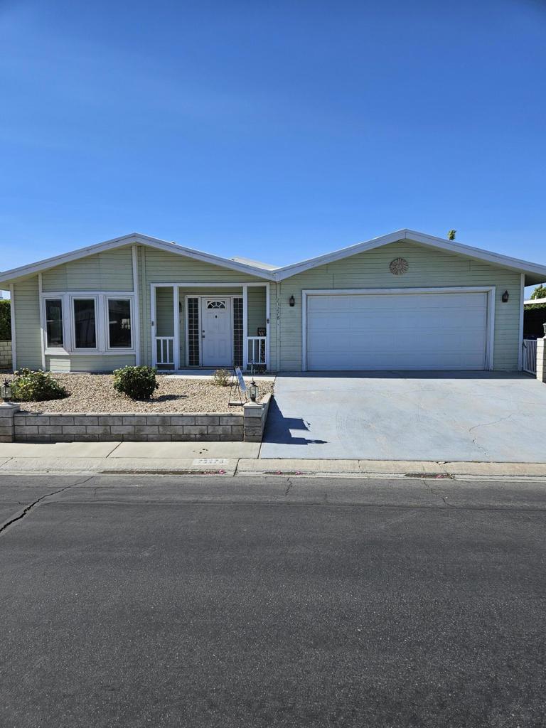 Spacious 2BR + Office, Home with rare 2 car, double-sided, golf cart access garage in Palm Desert Greens - You Own the Land! Welcome to this impressively spacious manufactured home in the sought-after 55+ community of Palm Desert Greens Country Club. Offering 1,920 square feet of comfortable desert living, this home is a rare find with features not often seen in the complex--including an attached 2-car garage with a double-sided golf cart door that opens to the patio. Inside, you will find 2 generously sized bedrooms, 2 full bathrooms, and a versatile den that functions perfectly as a home office, craft room, study, or guest space. Laminate flooring in the main living areas enhances the open-concept layout, while the kitchen and bathrooms feature easy-care tile. A built-in hutch adds charm and additional storage. Windows throughout have is either Triple-Paned or Double-Paned Glass throughout. The kitchen comes fully equipped with all shown appliances, while the primary and guest bedrooms include mounted TVs--move-in ready convenience! Ceiling fans throughout the home help keep it cool and comfortable year-round. Enjoy seamless indoor-outdoor living with covered patio access from both the living room and primary bedroom sliders--ideal for morning coffee or evening relaxation. Also, included is the abundant built-in storage throughout the home. A reasonable and an exceptional HOA fee of just $400/month, which delivers incredible value. This includes Spectrum Cable and high-speed internet, trash service, and unlimited golf on the community's private course. You will also have access to tennis and pickleball courts, 24-hour manned gated security, a clubhouse with a restaurant, and 22 active social clubs. For families, there's a kiddie park and pool, perfect for visiting little ones.This home offers the perfect blend of spacious living, privacy, and resort-style amenities, all in one of Palm Desert's most vibrant 55+ communities. Don't miss out on this rare opportunity to enjoy a truly exceptional lifestyle.
