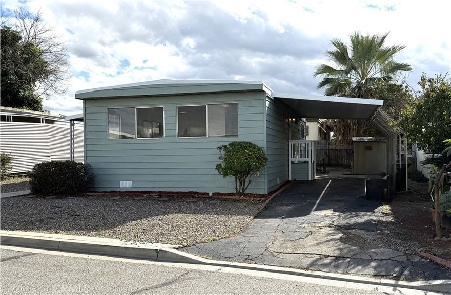 Welcome to King Arthur Mobile Estates, a charming all-age community in Riverside. This beautifully remodeled 2-bedroom, 2-bath home features numerous upgrades, including new carpet, flooring, interior paint, gas cooktop, built-in oven, dishwasher, farmhouse-style kitchen sink, countertops, and updated fixtures throughout. Enter from the covered side patio into a spacious living room that flows seamlessly into the dining area and kitchen. The convenient laundry area, complete with a full-size washer and dryer, is located just off the kitchen. The primary bedroom offers an en-suite bathroom with a walk-in shower, while the second bedroom is generously sized and adjacent to a full bath with a shower/tub combo. Additional highlights include a roomy lot with a large yard, a gas water heater, and an upcoming split HVAC unit installation for added comfort.