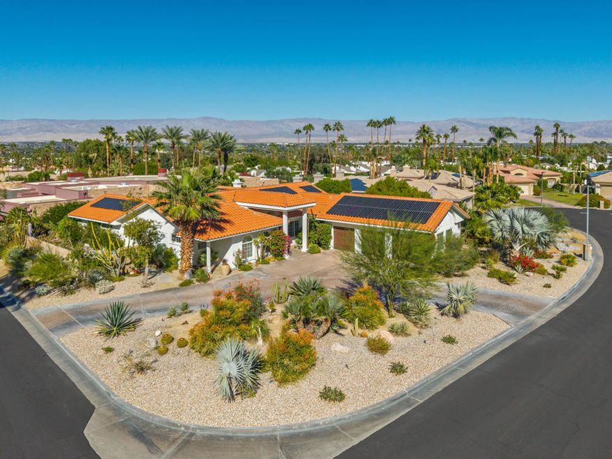 Perched on a premium corner lot in the gated hillside enclave of Vista Paseo, this custom built solar home offers exceptional privacy, energy efficiency, and desert living at its finest.  It's the only home in the neighborhood with a circular driveway - an elegant touch that sets it apart. Just moments from scenic hiking trails, public tennis and pickleball courts, and the world class shopping of El Paseo, this South Palm Desert gem combines location with lifestyle.  Spanning 2,790 square feet on nearly 16,000 square feet of land, the home features three spacious bedrooms - each with its own ensuite bath - a formal living and dining area with pool views, a bright and airy island kitchen, and a relaxed family room perfect for gatherings.  The oversized three car garage offers ample storage and flexibility.   The backyard features a beautifully finished Pebble Tec pool with new lighting and three tranquil water features.  Multiple patios offer both shaded dining and lounging areas with dramatic mountain views and ultimate privacy.  Recent upgrades include a high efficiency solar system with backup battery system, new luxury flooring in much of the home, a stunning $7,000 builtin refrigerator. and more.  Built in 1995 - decades newer than most South Palm Desert homes in this price range - this property stands out for its modern construction, curb appeal and unbeatable value. And with low HOA dues of just $140/month, its one of the best priced homes in the area with a three car garage. Don't miss this unique opportunity to own a stand-out property in one of South Palm Desert's most desired communities.