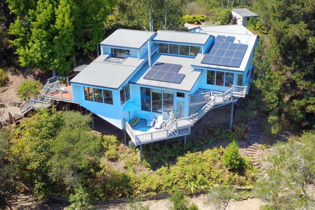 First impression you will notice upon entering this stunning Soquel retreat are the unforgettable ocean views. Wake up to breathtaking sunrises over the mountaintops, framed by large picture windows that invite the outdoors in. 3 bedrooms, 3 baths, this home is set on more than 7+ acres thoughtfully shaped into a private sanctuary. Meander through nature past majestic oaks, clusters of redwoods, and colorful gardens accented with fruit trees and flowers. Inside, multi-level, light-filled, open concept interiors highlight large windows, soaring ceilings, bamboo & oak floors, and artisan finishes. A wood-burning fireplace anchors the living room, set just below the chefs kitchen, which features a professional-grade Viking six-burner range, JennAir refrigerator, Shaws farmhouse sink, Miele oven, and a handcrafted Zellige backsplash made from recycled glass. The primary bathroom suite offers a peaceful retreat, complete with a meditative soaking tub, radiant heated floor, slate tile, tumbled marble, and a spa-like ambience. At the heart of the home, a vibrant indoor atrium bursts with light and color, centered around a graceful stone fountain that brings calm and serenity. BONUS: Great location! Just minutes from 41st Avenue, freeway access, medical offices, dining, and shopping.
