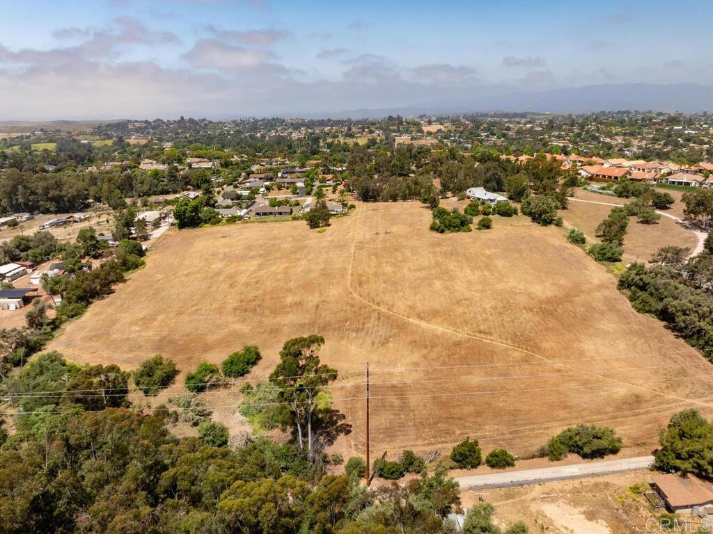 11.35 Acres of Prime Development Land in Fallbrook, California – 2 Legal Parcels Included Incredible Investment Opportunity in San Diego's North County! Discover a rare chance to own 11.35 acres of buildable, usable land in the heart of Fallbrook, CA—a community celebrated for its rural charm, scenic views, and close-knit atmosphere. This listing includes TWO LEGAL PARCELS, making it a standout investment for developers, custom home builders, or land investors. Location, Location, Location! Just off McDonald Rd., this centrally located property sits in a desirable neighborhood near established single-family homes—ideal for a new custom home community or luxury estate builds. This Land is a Must-See: *Two Legal Parcels – flexibility for development, resale, or holding for future value. • Usable, Level Acreage – perfect for building multiple homes, a private estate, or an equestrian retreat. • Zoned for Residential Use – maximize potential in an area with limited housing inventory. • Easy Road Access – near major routes, ensuring easy commutes and connectivity. • No HOA – more freedom, fewer restrictions. Central to Key Attractions: • 30 Minutes to Oceanside Beaches & Harbor – coastal living without the coastal price tag. • 20 Minutes to Temecula Wine Country – enjoy world-class vineyards just around the corner. • 56 Miles to Downtown San Diego – endless shopping, dining, and nightlife options within reach. Fallbrook Lifestyle Appeal: This picturesque town offers a peaceful, rural lifestyle with a vibrant arts scene, year-round farmers' markets, hiking trails, golf courses, and a welcoming, small-town vibe. Known as the “Avocado Capital of the World,” Fallbrook is a hidden gem in Southern California real estate. High Demand + Low Inventory = Smart Investment With a growing demand for single-family homes and limited land availability, this property is a golden opportunity for developers looking to capitalize on Fallbrook’s rising popularity.
