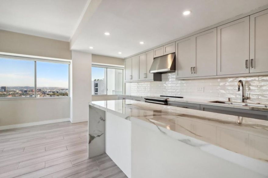 Exquisitely remodeled, this front corner unit at the Westview Towers showcases unobstructed, breathtaking city and mountain views.   The owner/designer spared no expense in the renovation, utilizing only the highest quality finishes to achieve a stunning result. Throughout the unit, Beaumaniere limestone floors and commercial-grade carpeting. Modern comforts include new central air conditioning as well as built-in speakers in most rooms. Notably, the kitchen features SieMatic cabinets, stainless steel appliances, and granite countertops. The primary suite is a retreat in itself, complete with a lavishly redone bathroom, while the spacious balcony offers an expansive view of Los Angeles.  The prestigious full-service building provides an array of amenities, including valet and guest parking, electric charging stations, a front desk concierge, and recently renovated hallways, lobby, rec room, pool area, sundeck, dog park, and gym.  West Hollywood's vibrant energy is mirrored in its abundant nearby amenities. High-end shopping, diverse dining options, and cultural hotspots like art galleries and theaters are all within reach. Outdoor enthusiasts will love the proximity to lush parks, while the nightlife offers endless entertainment with trendy bars and clubs.
