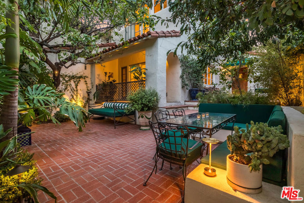 This stunning townhome with Old Hollywood charm is located just above the Sunset Strip, tucked away in lower Nichols Canyon. Part of The Courtney Desmond Estate (1926), Los Angeles Historic Cultural Monument #445, this townhome is 1 of only 5 unique homes that have rarely come to market in their storied near 100 year history. This beauty and charm of this extraordinary residence has been enhanced by a recent extensive and tasteful restoration, with thoughtful attention to detail, retaining the glamour of its romantic architecture. The home lives like a single family residence, while enjoying the ease of being a part of a small, idyllic community, sharing a tranquil pool, surrounding cabanas, and lush, manicured grounds. The gated entry opens to the expansive, yet private outdoor living surrounding the home which includes multiple water features, sitting areas, as well as a built-in sumptuous spa, a tranquil and lush European setting. The home has generous formal living spaces on the main level, with the elegant primary suite and additional 2 bedrooms and 1 bath on the second level. The authentic and meticulously selected finishes are evident throughout, with exceptional attention to detail.Each window overlooks verdant, leafy vistas, and provide a peaceful, quiet setting. Complete with its own private and gated parking, this rare, timeless, masterfully restored offering simply has it all.