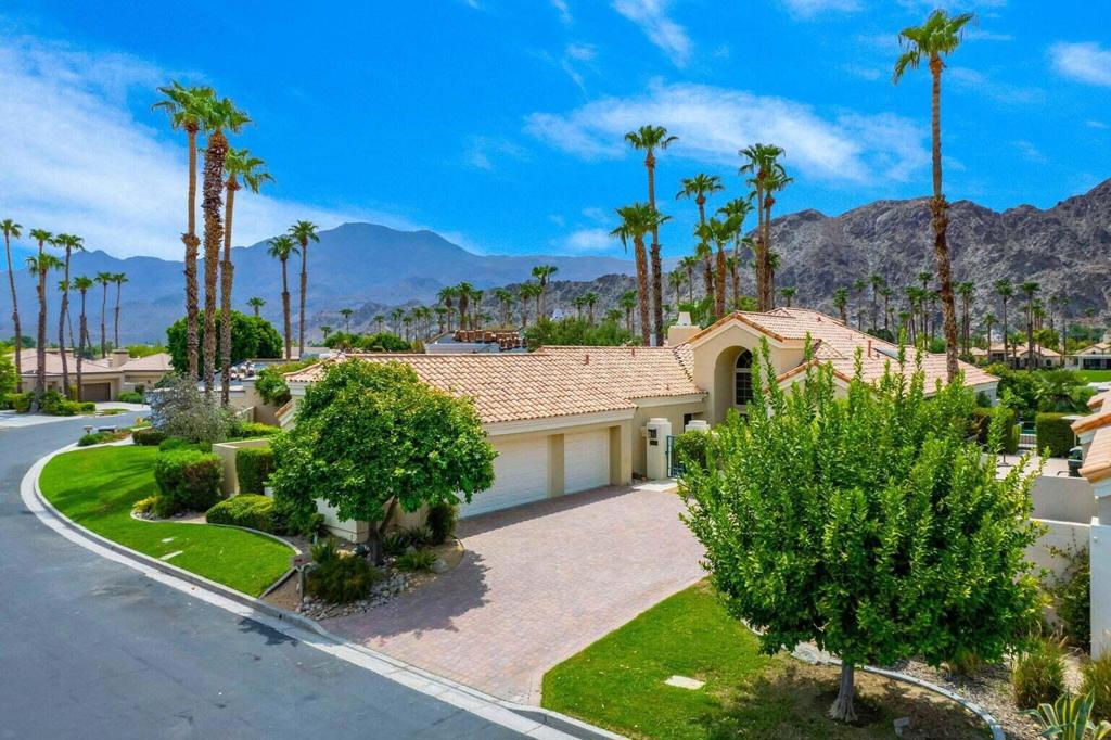 Breathtaking waterfront and mountain views highlight this splendid 3-bedroom, 4-bath home in PGA West. This highly sought-after open floor plan offers spacious living and floor-to-ceiling windows which showcase the amazing, unobstructed panoramic views. Step into the gourmet kitchen, featuring granite counters, a center island, and ample cabinet space. The large primary suite boasts dual vanities, separate shower, jacuzzi tub, and a generous walk-in closet. All 3 bedrooms are ensuite, offering ultimate privacy. Enjoy beautiful natural light, high ceilings, a marble fireplace, travertine floors, and a separate laundry room with a sink. Outdoors, an entertainer's dream awaits-featuring a sparkling private pool and spa, multiple patio areas, meticulously upgraded landscaping with artificial turf, fruit and palm trees, built-in gas BBQ, and a fire pit. Not convinced yet? This property also includes a fully OWNED solar system, a spacious garage with epoxy flooring, AC unit, golf cart storage area, and comes mostly furnished for an easy move-in. The PGA West lifestyle offers access to championship golf courses, fine dining, a state-of-the-art fitness center, tennis and pickleball. Call today to schedule your private showing!