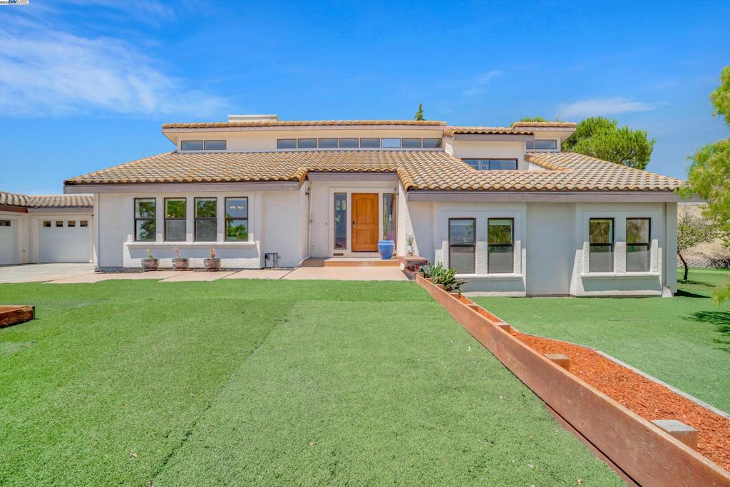 Welcome to this stunning luxury custom built 4 bedroom, 3 bath single-family home offering 3,006 sq ft of living space on 7.36 private acres with breathtaking panoramic views of Livermore. Designed with elegance and comfort in mind, this home features vaulted ceilings, a spacious 5-car garage, and fully paid solar. The gourmet chef’s kitchen is a true showstopper boasting exquisite custom cabinetry, elegant granite countertops, a walk-in pantry, and a grand 6-burner Wolf gas range. The newly remodeled spa-like master bathroom offers a luxurious retreat with premium finishes. Step outside to a beautifully landscaped backyard oasis featuring a basketball court and a mini soccer field perfect for outdoor enjoyment and entertaining. Enjoy serene twilight evenings from the charming front porch. Ideally located just minutes from the 580 freeway, downtown Livermore, and premier shopping centers, this property combines peaceful seclusion with everyday convenience. A rare opportunity to own a truly exceptional home with unmatched views and luxury finishes.