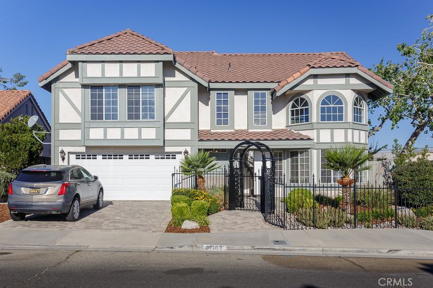 Set on a beautifully landscaped corner lot in the conveniently located Casa Verde neighborhood, this striking two-story home blends architectural flair with thoughtful updates. The entry opens to a dramatic living room with towering windows that flood the space with natural light and a graceful spiral staircase leading to the second floor.



At the rear of the home, the recently remodeled kitchen features white shaker cabinets, gold hardware, marble-look counters, and new stainless-steel microwave and dishwasher overlooking the backyard. Just off the kitchen, a cozy secondary living room with a traditional red-brick fireplace offers the perfect gathering space. The dining room’s large sliding glass door provides a lovely view of the backyard and extends the living area to the covered patio. A convenient first-floor powder room completes the main level.



Upstairs, a custom loft office with built-in shelving overlooks the living room below—ideal for remote work or study. The upper level also includes a remodeled and expanded bathroom with a freestanding tub under a sparkling chandelier. Formerly a bedroom, this area can easily be restored to a traditional four-bedroom configuration if desired. The spacious primary suite serves as the highlight of the second floor.



Exterior highlights include refreshed landscaping with new bark and plants, a lush green lawn, and a pergola-covered patio perfect for outdoor entertaining. A versatile detached building, fully wired for electricity, offers endless possibilities—workshop, studio, hobby space, or simply exceptional storage. Fresh paint inside and out gives the home a crisp, move-in-ready finish—just minutes from schools, parks, shopping, and freeway access.