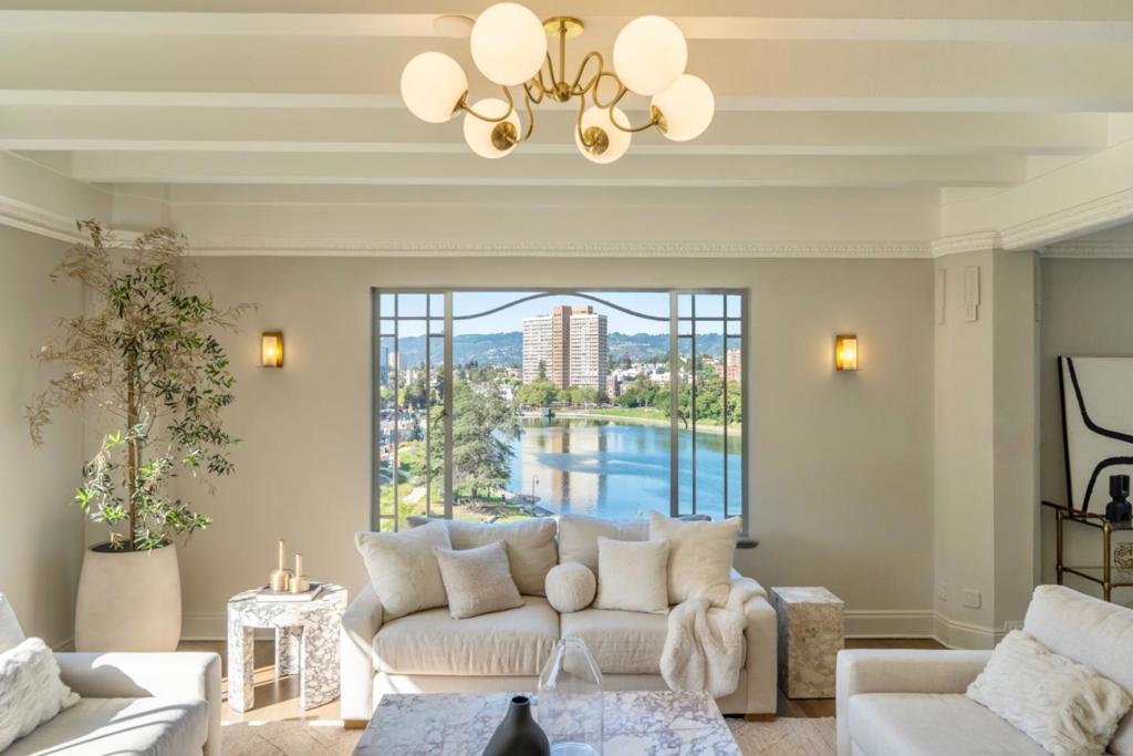 Relax into lakeside luxury at The Sparrow's Nest on Lake Merritt. Perched high above the city with unobstructed views of Lake Merritt, Snow Park, and Schilling Gardens, the Nest blends stunning views with classic grandeur and modern convenience. Perfectly located on the lake, yet blocks from top restaurants, music venues, and just three blocks from BART, this iconic building makes no compromises and offers the best of all worlds: stunning nature views AND an unbeatable metropolitan location. A storied 100 year history, WITH a restoration and gut renovation completed in 2024 providing updated systems, electrical, and copper plumbing. The bedroom wing features three spacious rooms, all en-suite with private baths and views of the garden and Snow Park. Panoramic views of the lake take center stage in all of the living areas: a family room off of the kitchen flooded with afternoon sun, a chef's kitchen with Bertazzoni gas range and oversized quartz island, luxurious soapstone-mantle fireplace'd living room, and dazzling dining room. A laundry room, private elevator entry, and 1 parking complete the home. With amazing views, an unbelievable location, classic style, modern systems and 2420sqft of room to spare, you'll want to settle in the moment you flutter in the door.