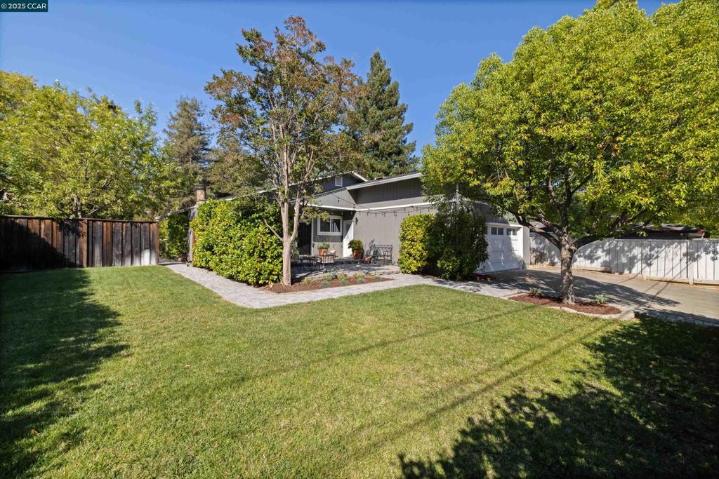 Tucked away on a quiet, private street in the highly sought-after Poets Corner neighborhood, this charming 4 bedroom, 2 bathroom home offers the perfect balance of Bay Area convenience and serene seclusion. Surrounded by lush tall hedges, this .25 acre property feels like a hidden garden, providing multiple outdoor spaces ideal for both relaxing and entertaining. Inside, the home boasts beautiful oak hardwood floors throughout all living areas, adding warmth and character. The updated kitchen features dual skylights, an abundance of cabinetry, a stone farm sink, solid stone countertops, and eat-in bar, perfect for those rushed mornings getting out the door. The family room is open and bright, with plenty of space for entertaining friends or staying in with the family. Oversized primary with en-suite gives you the space you desire, while still providing 3 more well-sized bedrooms. Designed for easy living and hosting, both the front and back yards offer large lawns and patios, for effortless indoor-outdoor living. Close to great local K-12 schools, downtown Pleasant Hill, BART, freeways, shops, parks, trails and more!