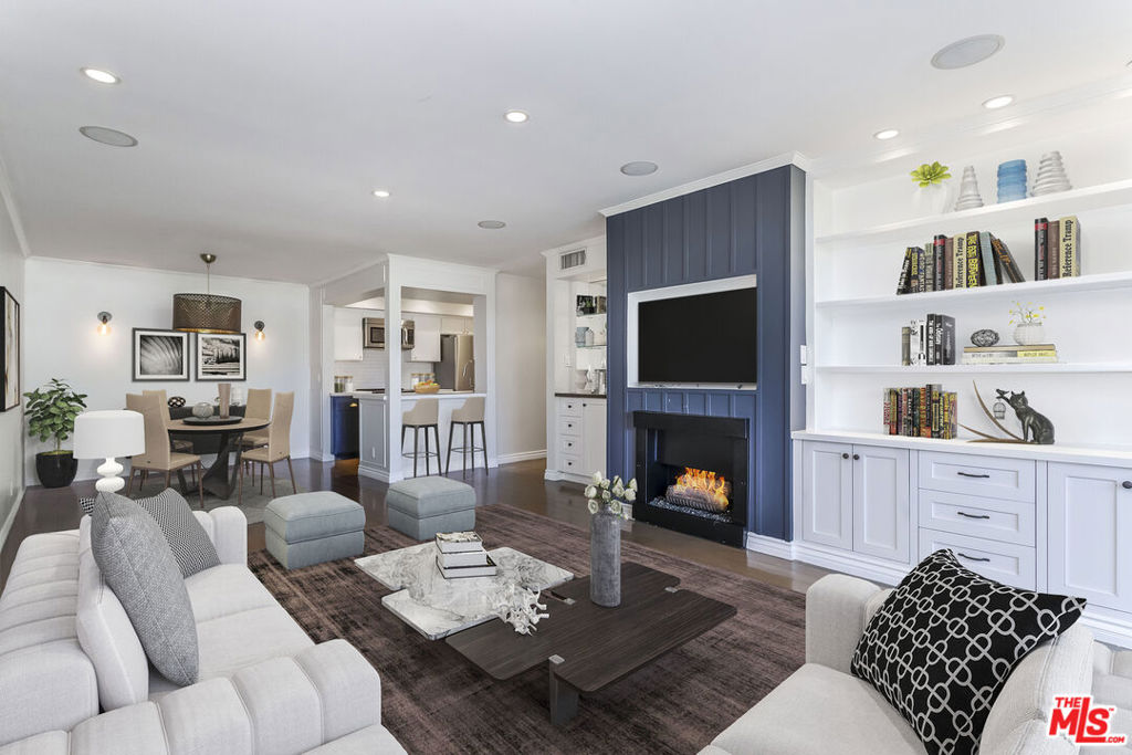 Located in the highly sought-after Doheny Terrace at the crossroads of West Hollywood and Beverly Hills, this upgraded condominium is one of the most desirable in the building. Quiet, private, and extensively improved, it sits well above street level with southern exposure. Unit #311 features rich hardwood flooring throughout, fireplace, a reimagined kitchen with high-end appliances and streamlined cabinetry, and thoughtfully renovated bathrooms with quality fixtures and finishes. Oversized windows bring in abundant natural light, and the floor plan offers a balance of separation and flow, making it ideal for both entertaining and working from home. Both bedrooms are generously sized with ample closet space, and the primary suite includes an en-suite bath and ample closet space. Additional features include IN-UNIT LAUNDRY (stacked machines), dedicated 220v electric car charger, central HVAC, and a quiet balcony facing Cynthia Street. The building, located in the highly desirable Norma Triangle, offers amenities such as a sparkling pool, sauna, gym, and a shared laundry facility (as mentioned, this unit has its own in-unit laundry). The best of Los Angeles' dining, shopping, and nightlife is just outside your door. Two gated tandem parking spaces near the elevator and low HOA dues of $682.40/mo., which includes earthquake insurance for the building. Seller to pay pending assessment, which is $87/mo. for building improvements. Photos are virtually staged.