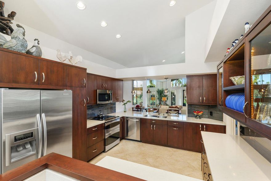 You won't want to miss this impeccably maintained, highly upgraded two-bedroom + Den, three-bathroom Dallas model.   High vaulted ceilings with transom windows creates an open and airy atmosphere, with golf course views easily enjoyed from the main living areas. The open floorplan of almost 2,300 SqFt features two primary bedrooms, with a den that could be easily converted to a third bedroom.  Floor to ceiling decor lighting creates a warm ambiance to highlight the custom millwork.  Loads of seating with front and back patios.  Expansive upper and lower conversation areas, showcase the mountain and distant water feature views from the golf course patio off the living room.  While the sunny, tiled front courtyard is a private outdoor entertaining space, complete with built-in BBQ.  There is direct access to the garage from the front courtyard and the house.  The upgraded finishings extend into the oversized 2 car + golf cart garage with built in cabinets.  This home comes TURNKEY FURNISHED with designer furnishings, allowing for a seamless move-in experience. Golf cart included!! The Lakes Country Club offers several dining options, 27 holes of golf, tennis, pickleball and 44 swimming pools located conveniently throughout the private guard-gated community.