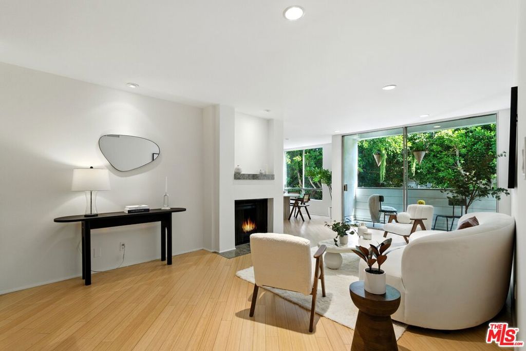 Welcome to this beautiful second-floor condo in Park Oakhurst, an exclusive 15-unit building on Oakhurst, one of Beverly Hills' most desirable tree-lined streets, just north of Beverly Blvd. Close to West Hollywood , Rodeo Drive, the Wallis Annenberg Center for the Performing Arts, the Civic Center, and the most iconic dining and luxury shopping in the country. This spacious residence offers a custom Italian kitchen with granite countertops, frameless cabinetry, and a generous pantry perfect for entertaining. light color floors run diagonally throughout the unit , while large windows fill the home with natural light and tranquil tree views. The oversized primary suite includes a spacious closet and an en-suite bath. Both bedrooms are well-proportioned with ample storage. Enjoy the convenience of in-unit laundry, central air and heat, and two parking spaces in a secure underground garage with additional storage. The controlled-access building features remote garage entry, updated lobby , shared courtyard, and security cameras on every floor. Low HOA dues include earthquake insurance, hot and cold water. Located just a short stroll from Cedars-Sinai Medical Center, farmers markets, and everyday conveniences, this condo is also within the highly rated Beverly Hills School District and benefits from premium Beverly Hills city services. Don't miss the chance to personalize this home and experience luxury living in the heart of 90210. Park Oakhurst building upgrades include Butterfly Mx intercom, New "cool" roof application (2020). painting of the exterior of the building, remodeling of the common courtyard, new guest parking space, Addition of a dog run and so much more! Balcony inspections have also been completed and passed.