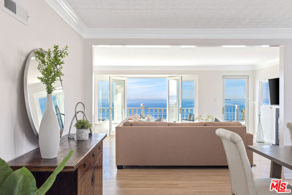 Panoramic ocean view penthouse style three story townhome, on one of the premier view sites in the city. Centrally located west of Highland, near great restaurants, schools and shops. Located in the coveted Sand Section of Manhattan Beach. Light and bright with commanding views from Palos Verdes to Malibu on two floors and just 6 doors from the beach on Bayview makes this the ultimate coastal living retreat. Best value of price per square foot, with an oversized 4 car indoor garage and driveway providing parking for up to 5 cars on-site. With 2 bedrooms, 3 baths with 2,200 sqft of living space and 3,000 sqft overall, affords the possibility of adding another bedroom. The sweeping 20' long sundeck is ideal for sunbathing while watching surfers and dolphins cruise by. The secluded garden offers a unique spot for relaxation. This home features sizable living and dining areas with ocean views, a well-appointed kitchen with nook, pantry and stainless-steel appliances. The large ocean view primary bedroom suite offers a walk-in closet, a large shower, and a relaxing jetted tub. The second en-suite bedroom includes bathroom with dual sinks and two roomy closets, ensuring ample space and comfort. The home is adorned with white-washed wood floors, a romantic wood-burning/gas fireplace, granite countertops, soundproofing, double-glazed windows, and copper plumbing. The separate laundry room with a built-in washer and dryer enhances functionality and convenience. Located in a peaceful setting, this home offers quick access to the beach, surfing, cycling, and walking on the Strand. Enjoy all that Manhattan Beach has to offer, including top-tier restaurants, exceptional schools, and year-round sports. Enjoy the ultimate beach lifestyle with this wonderful home.