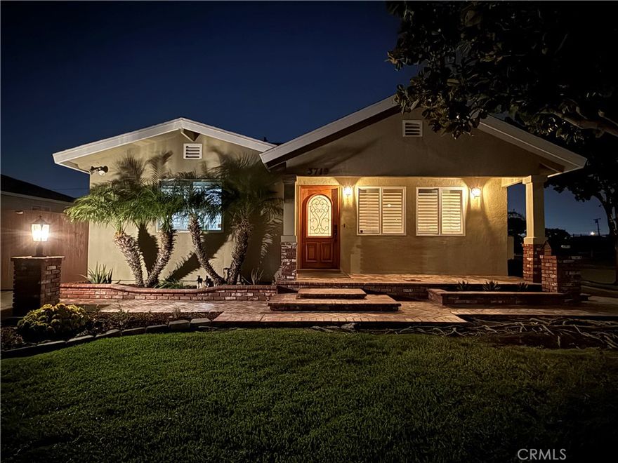 Charming, curb appeal, single-story residence perfectly situated on a desirable corner lot. This home combines timeless essences with thoughtful layouts, creating a warm and inviting space both inside and out.   From the moment you arrive, the curb appeal shines with a lush green lawn, mature shade tree, and an elegant brick-accented walkway leading to the covered front porch. The freshly landscaped flower beds and decorative exterior lighting add to the inviting ambiance.   Step inside to discover a bright and airy layout featuring large dual-pane windows with custom plantation shutters, wood flooring that fill the home with natural light while providing privacy. The spacious living areas are perfect for both relaxation and entertaining.   The open floor plan flows seamlessly, with vaulted ceilings, well designed recessed lights and abundant natural light enhancing the airy ambiance. This home offers 3 well-appointed bedrooms adorned with calming neutral tones, plush carpeting, and designer finishes. Each room is a serene retreat, complete with ample closet space. The two spa-inspired bathrooms are elegantly designed with granite countertops, dual vanities, and soaking tubs, complemented by sleek glass-enclosed showers, providing both elegance and functionality.   Outside, enjoy a private patio retreat with ample room for gatherings, gardening, or simply unwinding under the California sun. A wide gated driveway and detached 2-car garage provide plenty of parking spaces.   Additionally, this property features a bonus workshop of approximately 200 sqft -  permitted, offering additional space for creative projects, hobbies, or extra storage.   Conveniently located near parks, schools, shopping, and major freeways, this home is ideal for families and commuters alike. Don’t miss your chance to own this exquisite home. Contact us today for a private viewing!