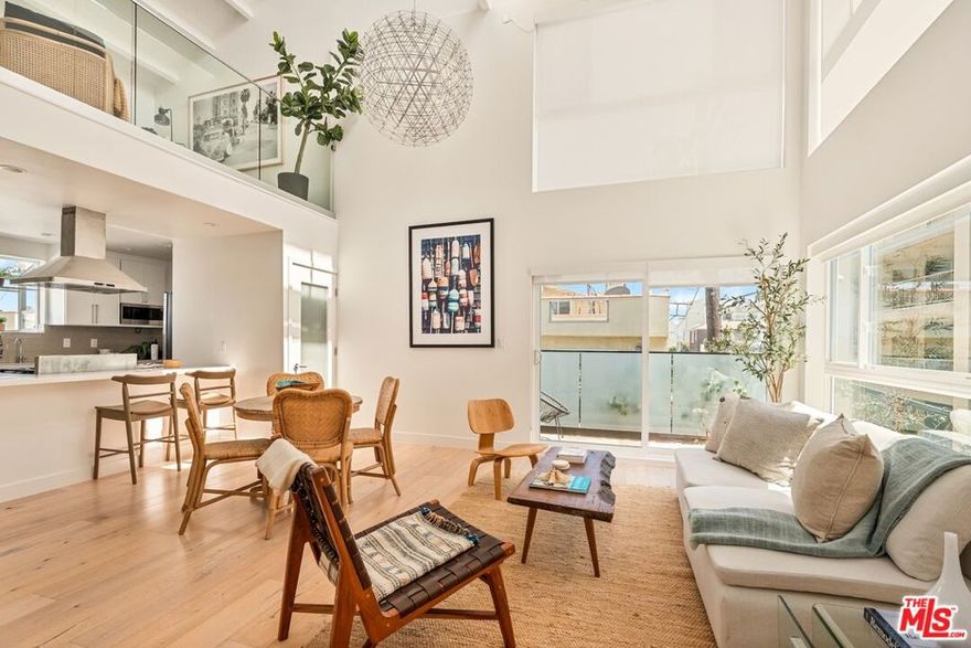 Fully Renovated, 2 Bed + 2 Bath + Loft + Roof deck + Side by Side Garage - Multi-Level beach condo, perfectly positioned on the coveted Marina del Rey Peninsula! Light & airy, south-facing with large windows highlighting the modern architecture - Dramatic 2-story ceilings accentuate the living room with rich wood detailing & glass railings, gorgeous wide plank hardwood floors elevate the modern aesthetic. The chef's kitchen is a showstopper, boasting custom cabinetry, luxurious stone countertops, stainless steel appliances, and a convenient eat-in bar-perfect for casual meals or entertaining guests. With two generously sized bedrooms and two stylishly updated bathrooms, there's plenty of space to relax and recharge. Ample closet space adds practical appeal. Upstairs, a versatile loft space makes an ideal home office or creative studio, leading to a private rooftop deck where you can soak up the sun or enjoy peaceful evenings under the stars. The home also includes a rare two-car side-by-side garage with electric vehicle charger for added convenience. Located just steps from the sand on the Marina del Rey Peninsula - moments from all the best this amazing area has to offer -- trendy cafes, acclaimed restaurants, Abbot Kinney, Venice Canals, main channel, Fisherman's Wharf, and exquisite shopping and entertainment. This is coastal living at its finest. You can watch the sunset on the beach every night just steps away!