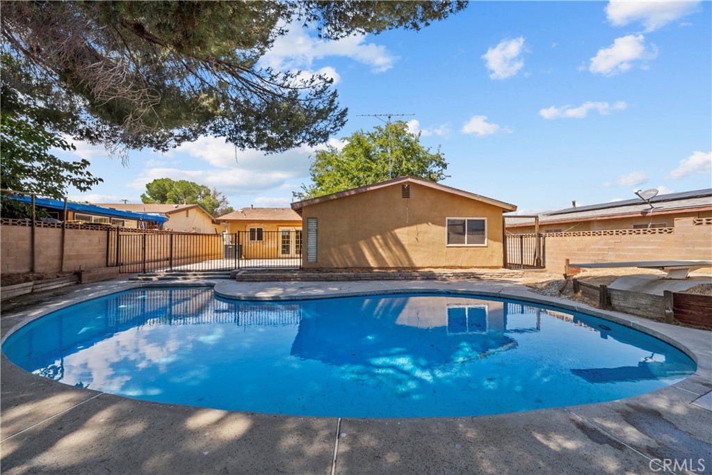 Welcome to 44408 Denmore Avenue! This inviting 4-bedroom, 2-bath single story pool home combines comfort, style, and an ideal layout for everyday living. Step inside to find hardwood and tile flooring throughout the main living areas, complemented by brand new carpet in the bedrooms. The spacious living room features a cozy wood-burning fireplace and plenty of natural light through dual-paned windows. The kitchen is designed for both function and flair with granite countertops, stainless steel appliances, and an open flow into the dining and family spaces perfect for entertaining. The primary bathroom bathroom has been beautifully updated, while the additional bedrooms provide flexibility for family, guests, or a home office.
Enjoy warm California days in your generous backyard, complete with a sparkling pool, patio space, and room to host gatherings. Additional upgrades include a newer AC condenser, furnace, and water heater for peace of mind. With its open floorplan, desirable features, and a great outdoor space, this home is ready to shine with your personal touch. NO HOA, NO MELLO ROOS!