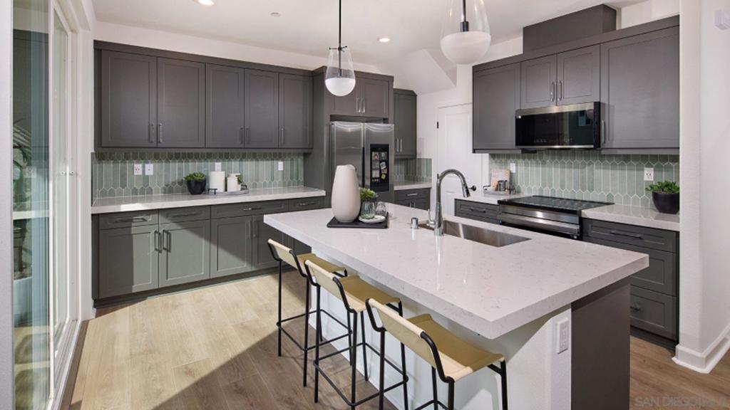 This home is ready for a quick move-in and has upgraded backsplashes and flooring. The kitchen shares a footprint with the Great Room on the second floor of this new three-story townhome, and a deck is easily accessible off the main living area for seamless indoor-outdoor transitions. Two bedrooms can be found upstairs, including the luxurious owner’s suite, complete with a private bathroom and walk-in closet. A two-bay garage completes the home. The Trails is a brand-new masterplan with single-family and attached homes in Carmel Mountain Ranch, San Diego, CA. Five communities of attached homes now selling! Lavender is a collection of brand-new townhomes for sale within The Trails masterplan in San Diego, CA. Residents enjoy a great central location and easy access to I-15 and 56 freeways for simplified commutes and getting around. The community is conveniently close to shopping at Carmel Mountain Ranch and UTC, 4S Ranch, Del Sur and more. Students will attend schools within the Poway School District.