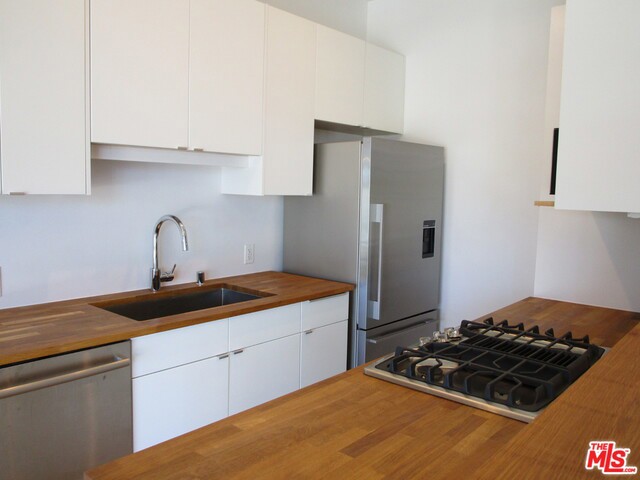 Step into this lovely, bright, airy home just blocks from the beach with convenience to freeways and close shopping. This sunny two bedroom was just remodeled in 2015 and was designed for private living with all the thoughtful details an owner would love. Spacious two bedrooms with 1.75 baths, this condo offers gorgeous floor to ceiling windows, hardwood floors, stainless steel appliances and washer/dryer in the unit. Bring your tennis racket and play on the paddle board court, grab your suit and hop in the sparkling pool and hot tub. And for a true outdoor beach city living, there is a barbecue and patio entertaining space. 2 side by side parking in this very secure and serene building. Stroll to the Beach! A perfect place to call home!